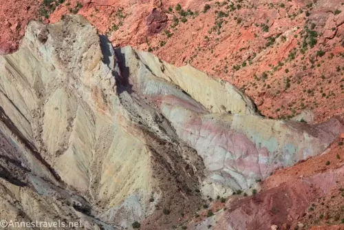 Colorful stripes below red hillsides in Upheaval Dome