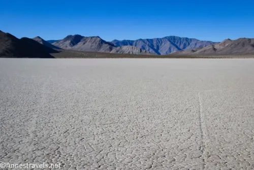 Views south across the Racetrack Playa to desert mountains against the blue sky 