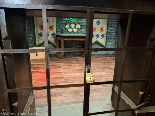 An owl lock on a gate in front of a second part of the Nocturnal Keep Escape Room