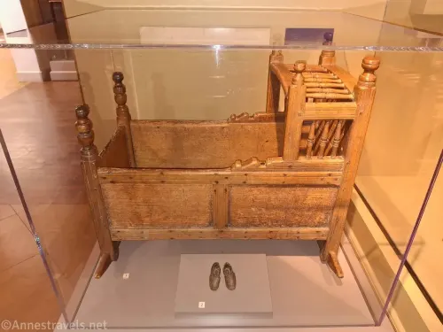 A Pilgrim wooden cradle and baby shoes in the basement of Pilgrim Hall, Plymouth, Massachusetts