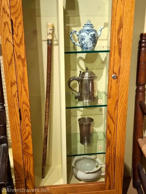 A wooden cabinet with dishes and other things from the Pilgrims in Pilgrim Hall, Plymouth, Massachusetts