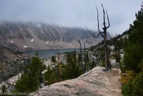 Following the rock path down to Glacier Lake below heavy cloud cover in the Beartooth Mountains of Custer-Gallatin National Forest, Montana
