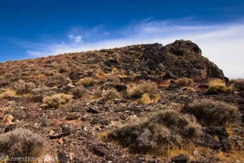 Hiking up a hill on the rim of the Amargosa Valley above Echo Canyon in Death Valley National Park's Funeral Mountain Range, California