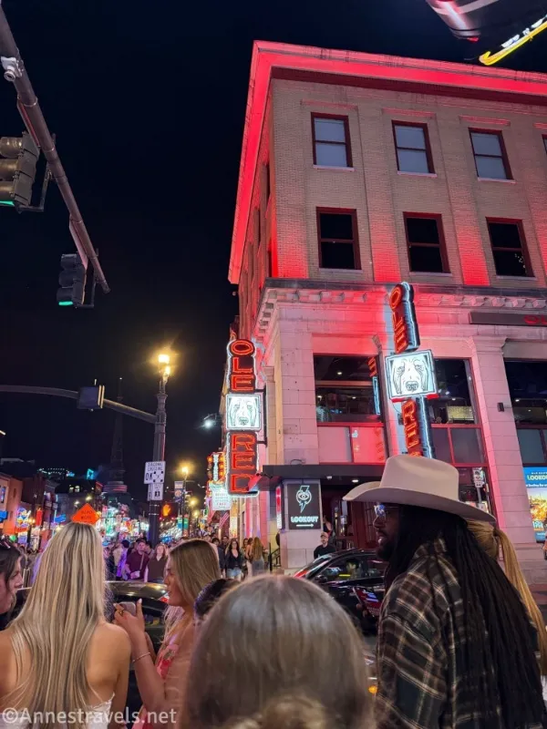 A sign for Ole Red, people, and an old building in a city 