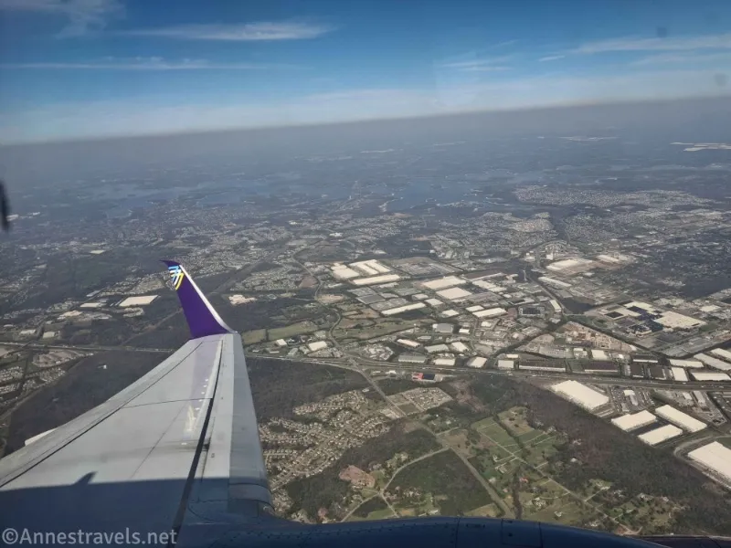 An airplane wing and views down to the ground 