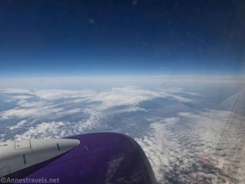 Clouds below the engine of an airplane