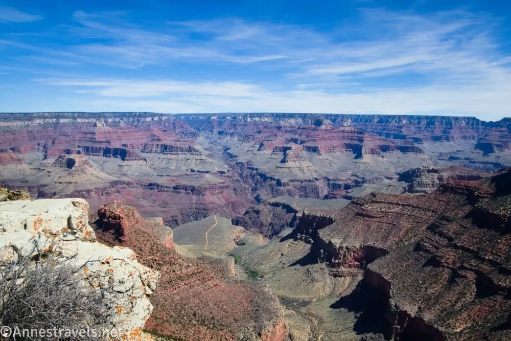 The Grand Canyon below blue skies with clouds