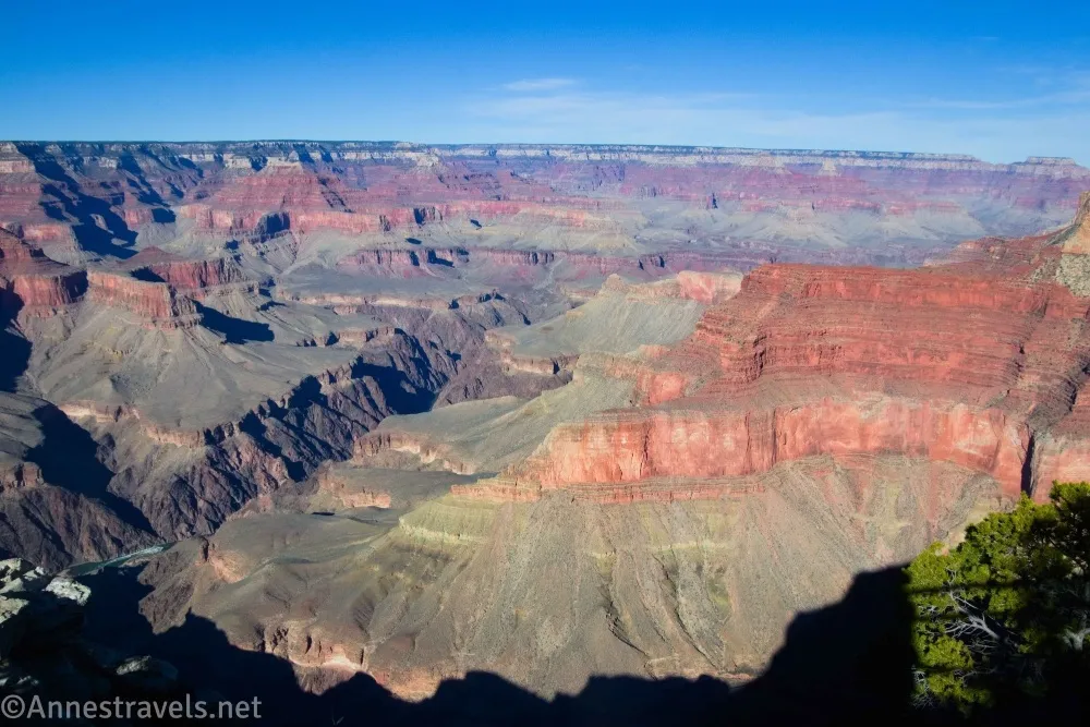 A red cliff and many more buttes and canyons in the Grand Canyon