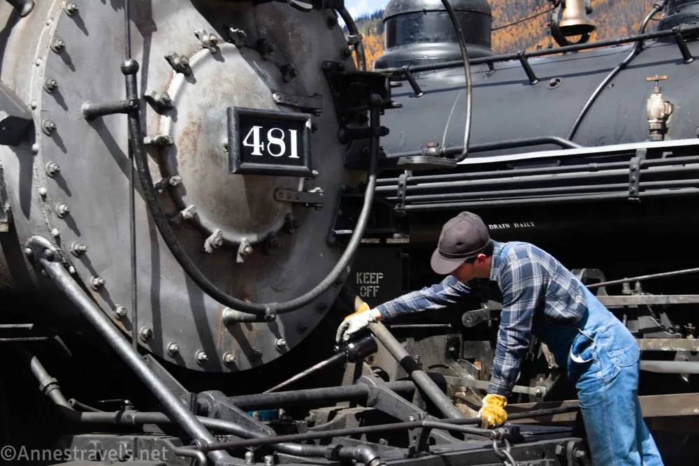 A engineer oiling Locomotive 481 on the Durango & Silverton Railroad, Colorado