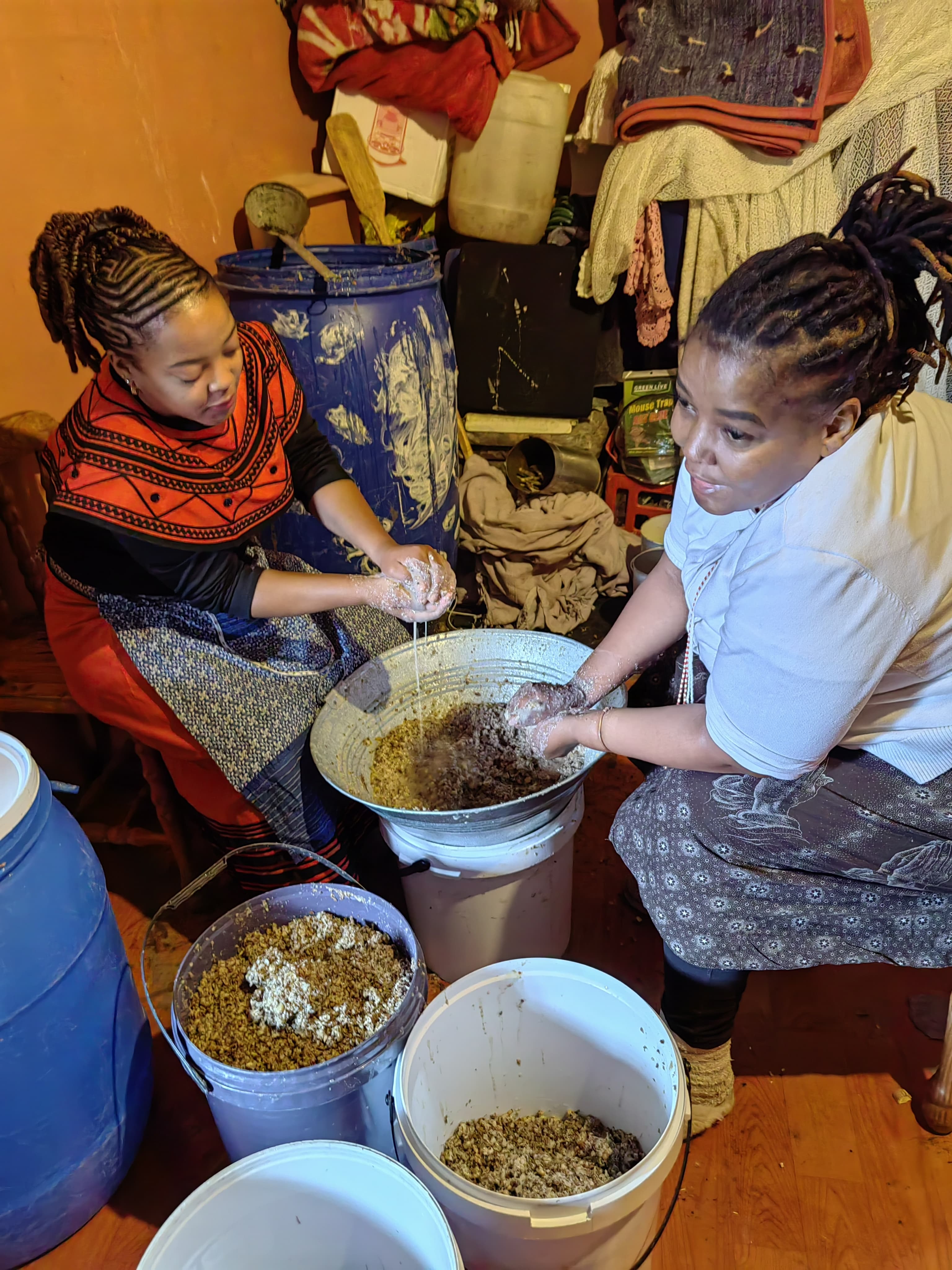 Brewing umqombothi together, hands in the grain