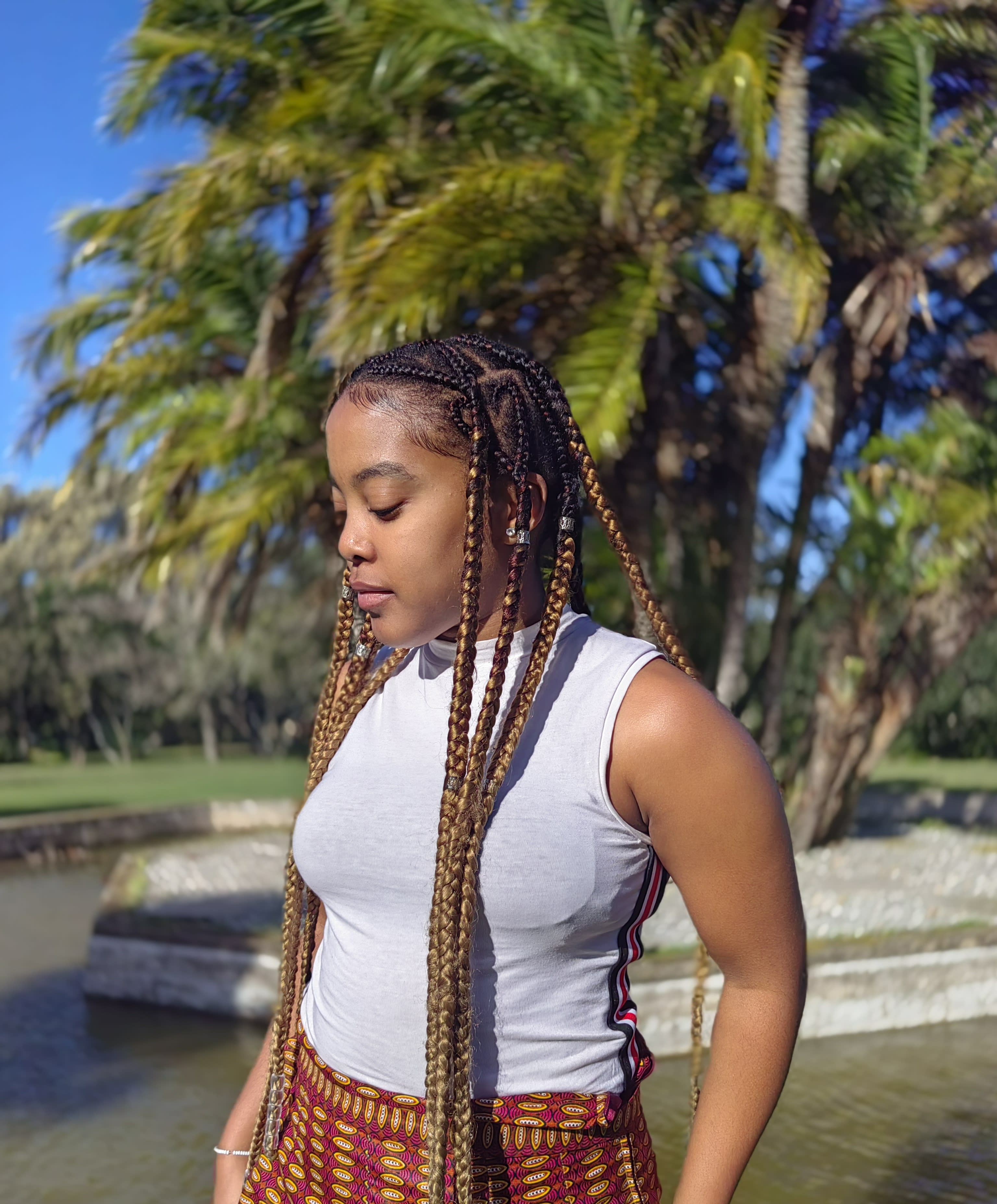 Honey braids and silver beads in golden light