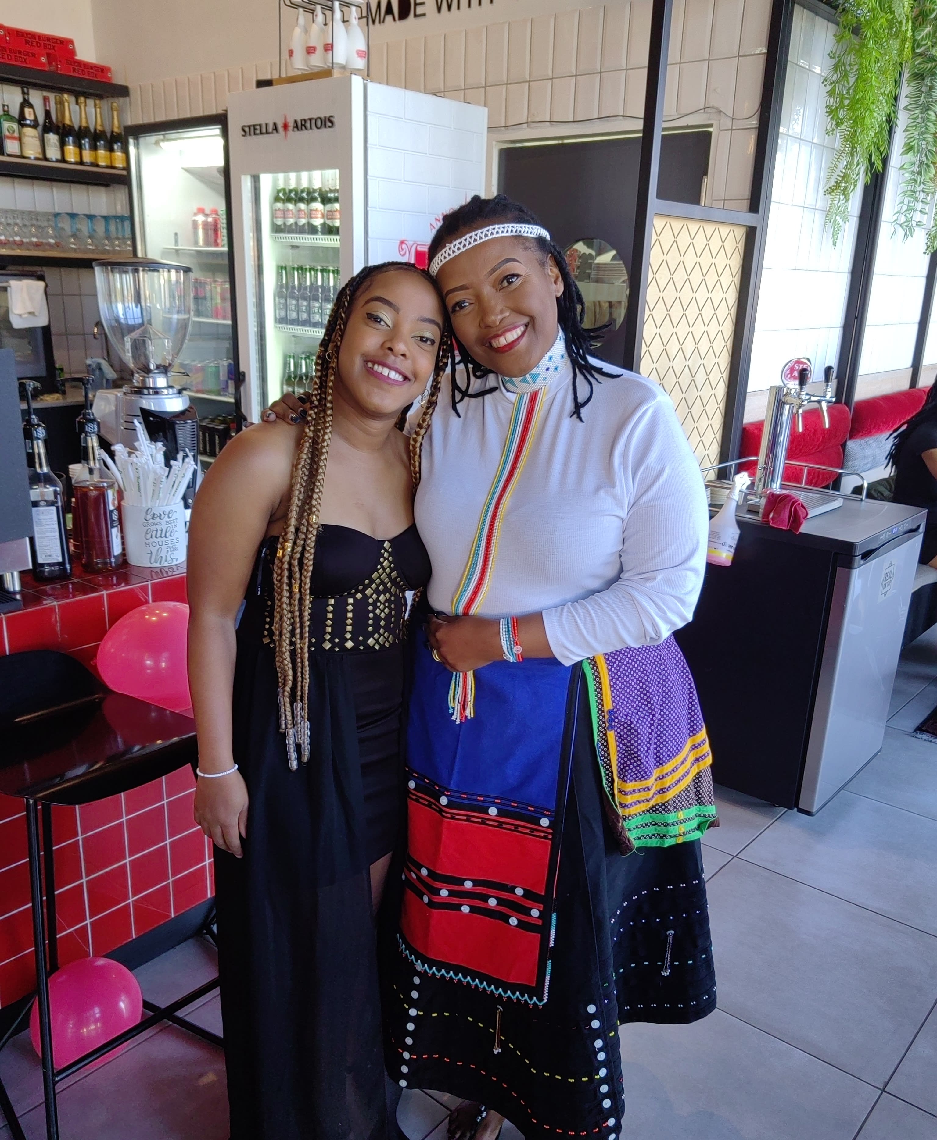 An embrace with an elder in blue Sotho beadwork