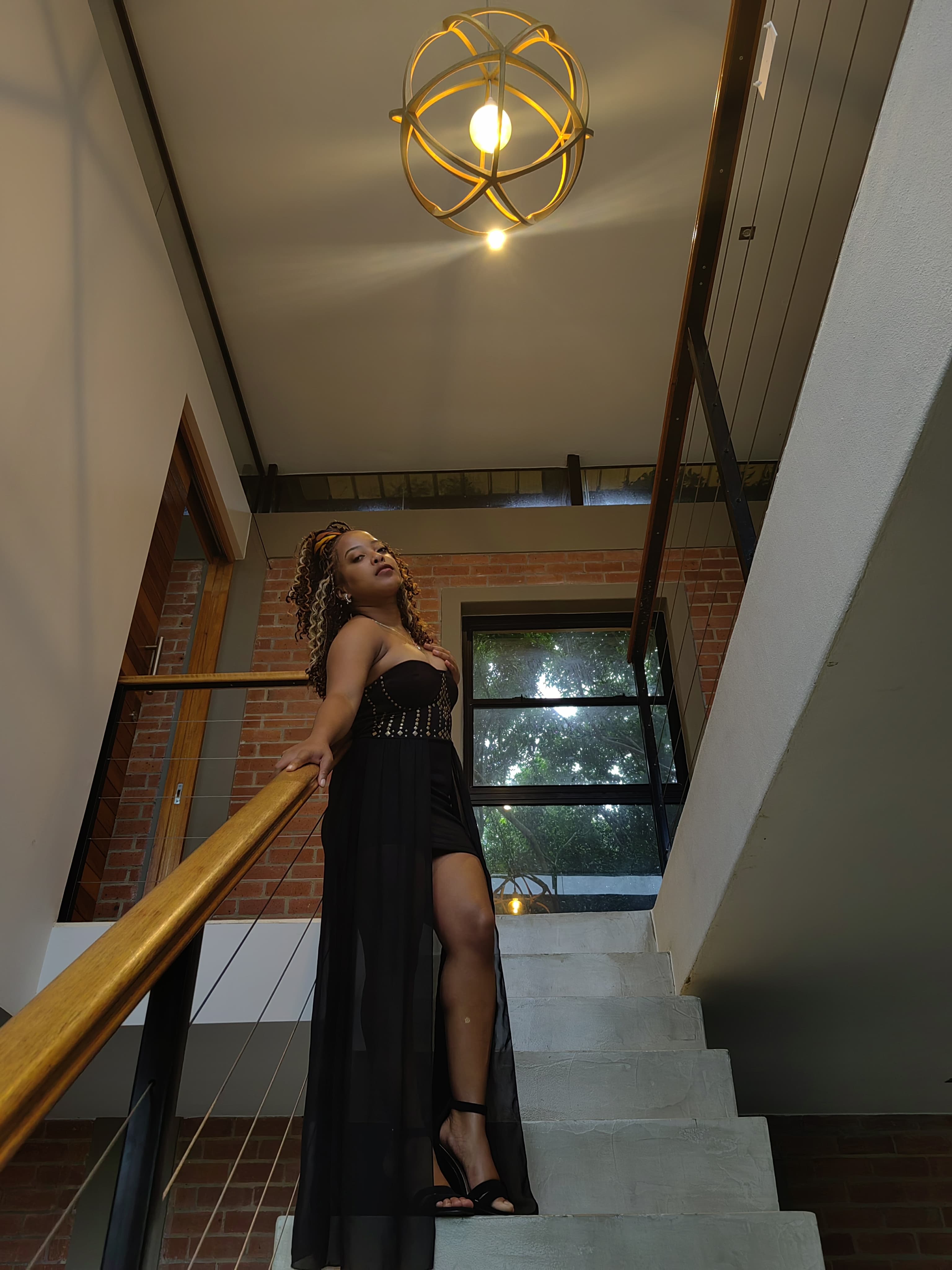 A regal beaded gown beneath a gold orb