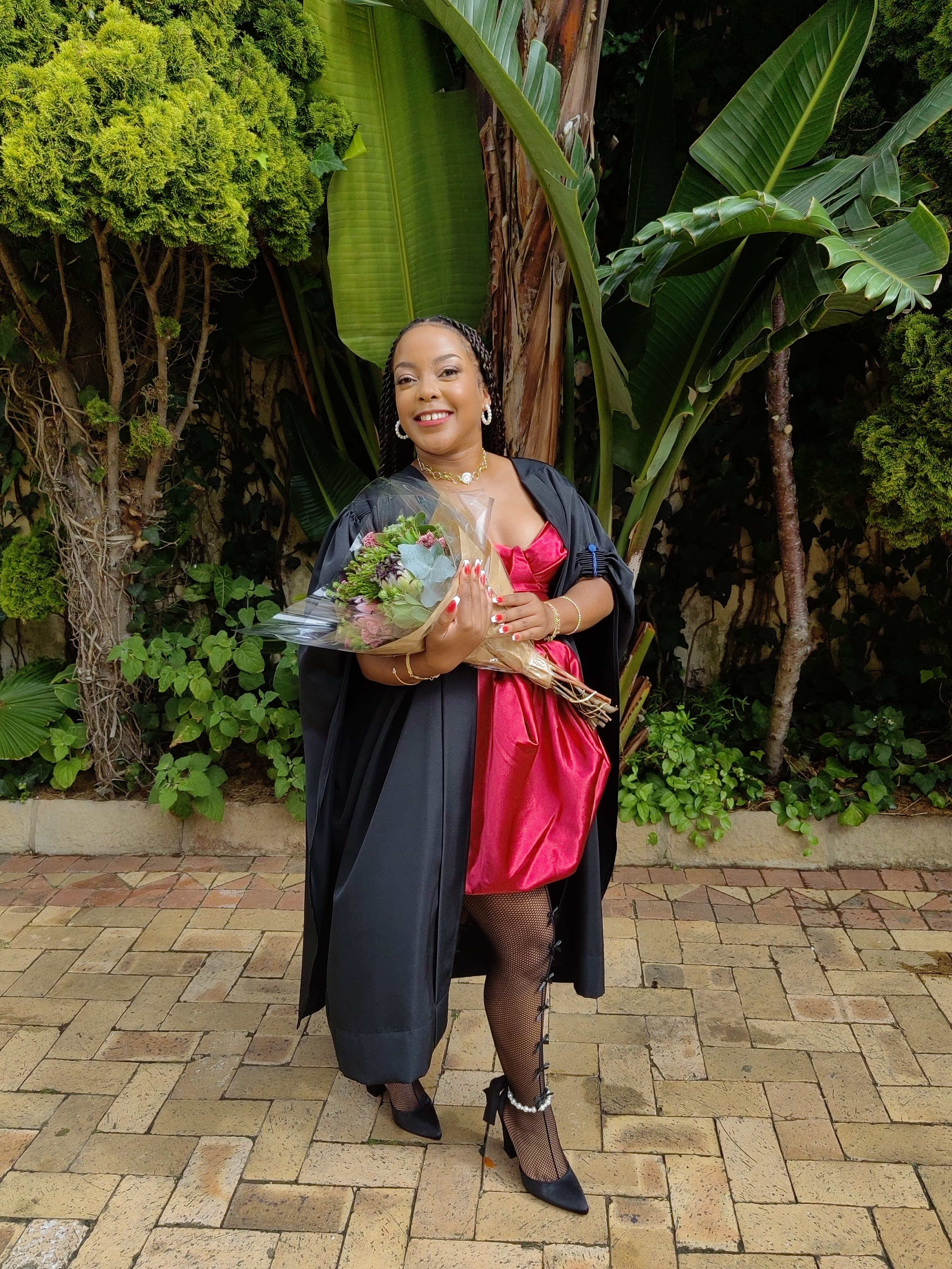 Graduation — magenta dress and gown with a bouquet