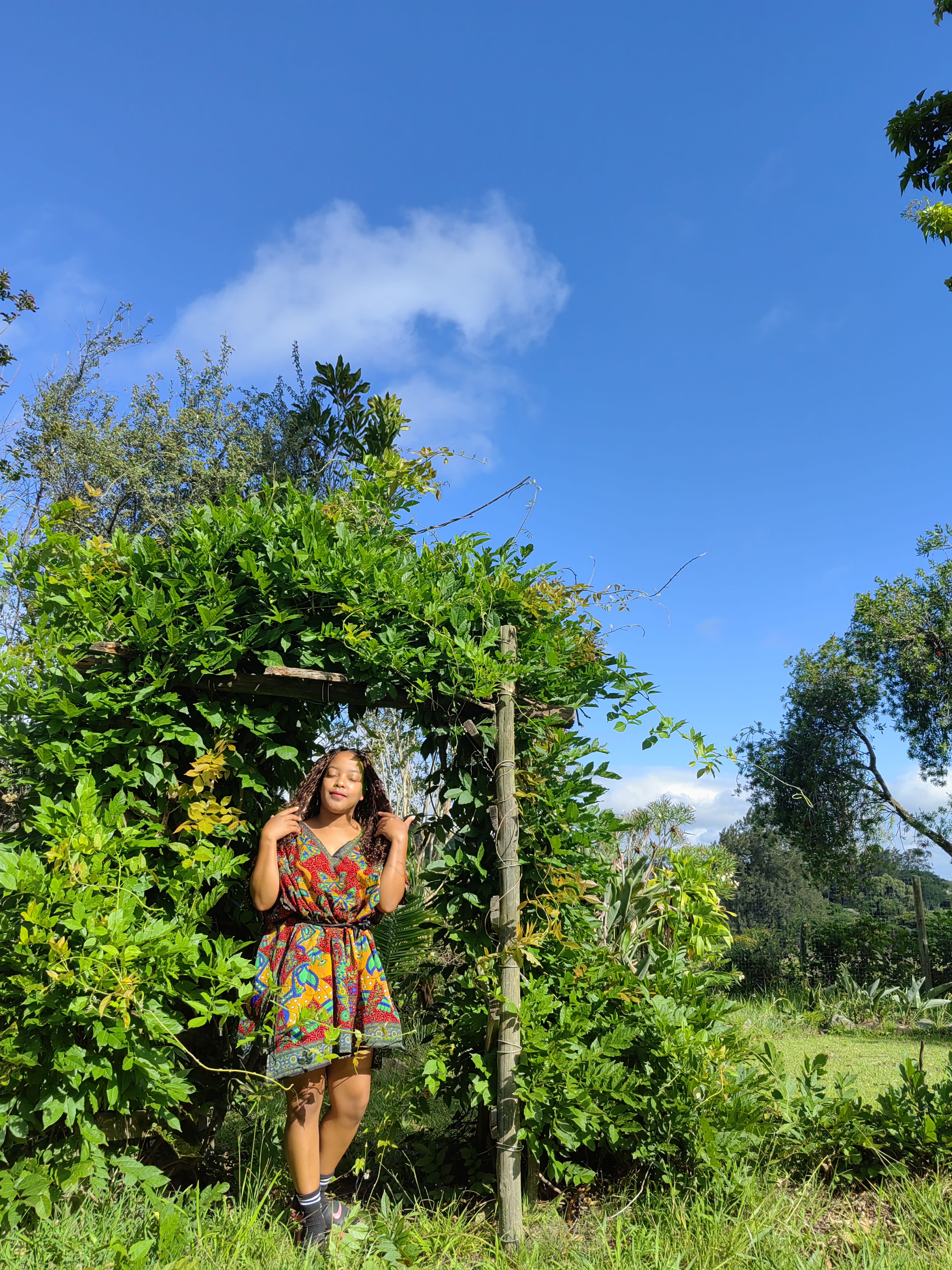 Laughing under a green arbor in African print