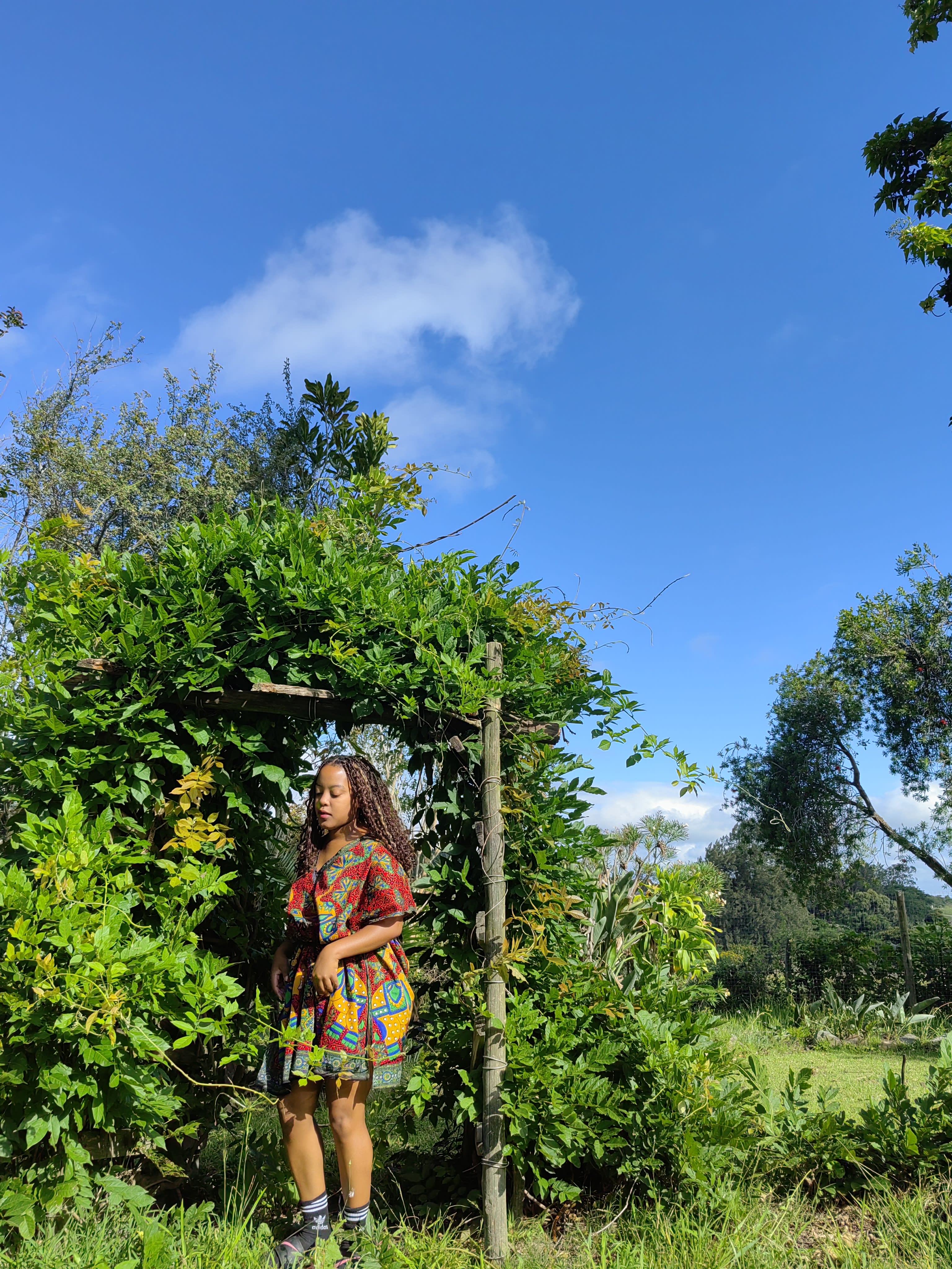 Poised in the arbor in a print co-ord
