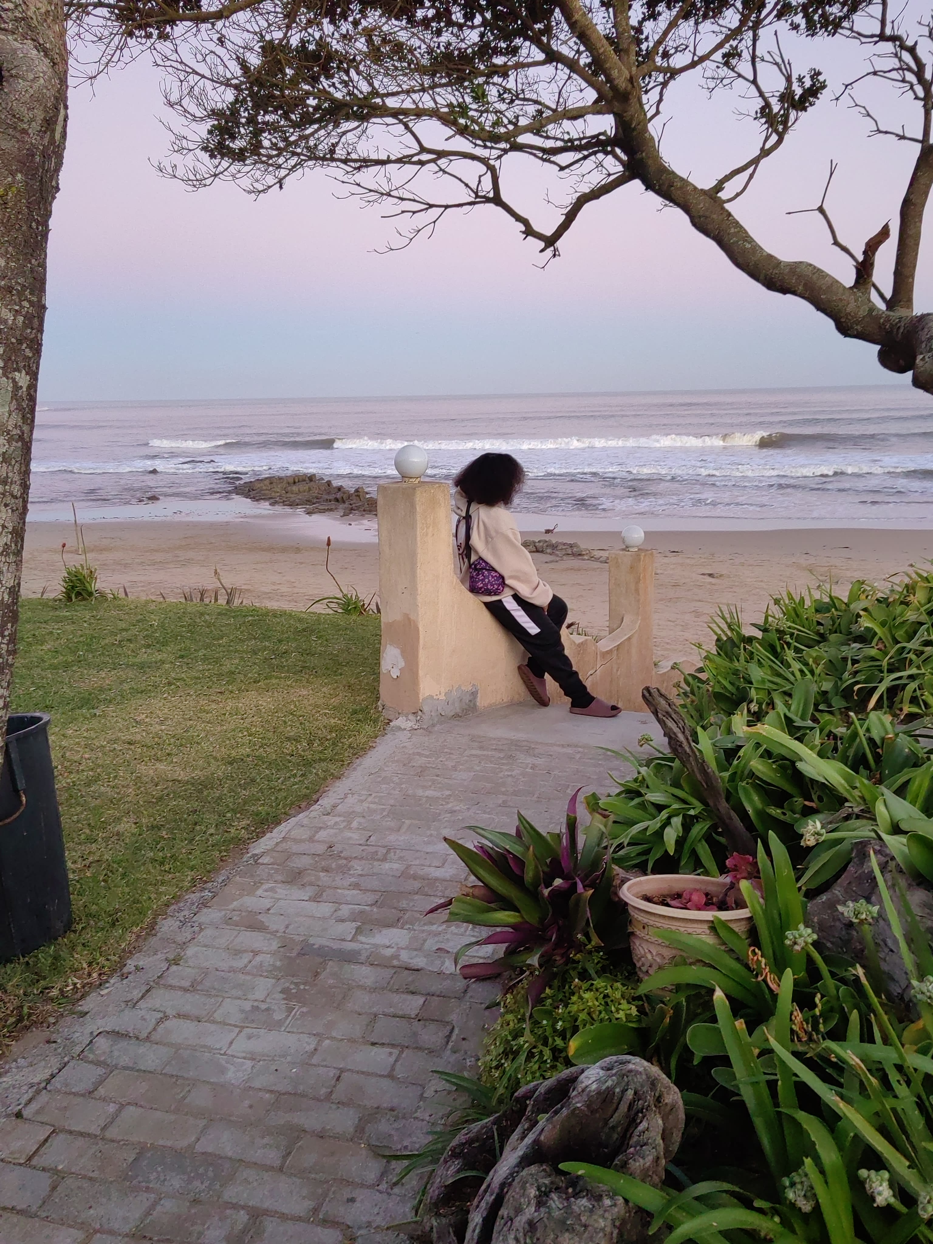 On a sea wall at pastel dusk