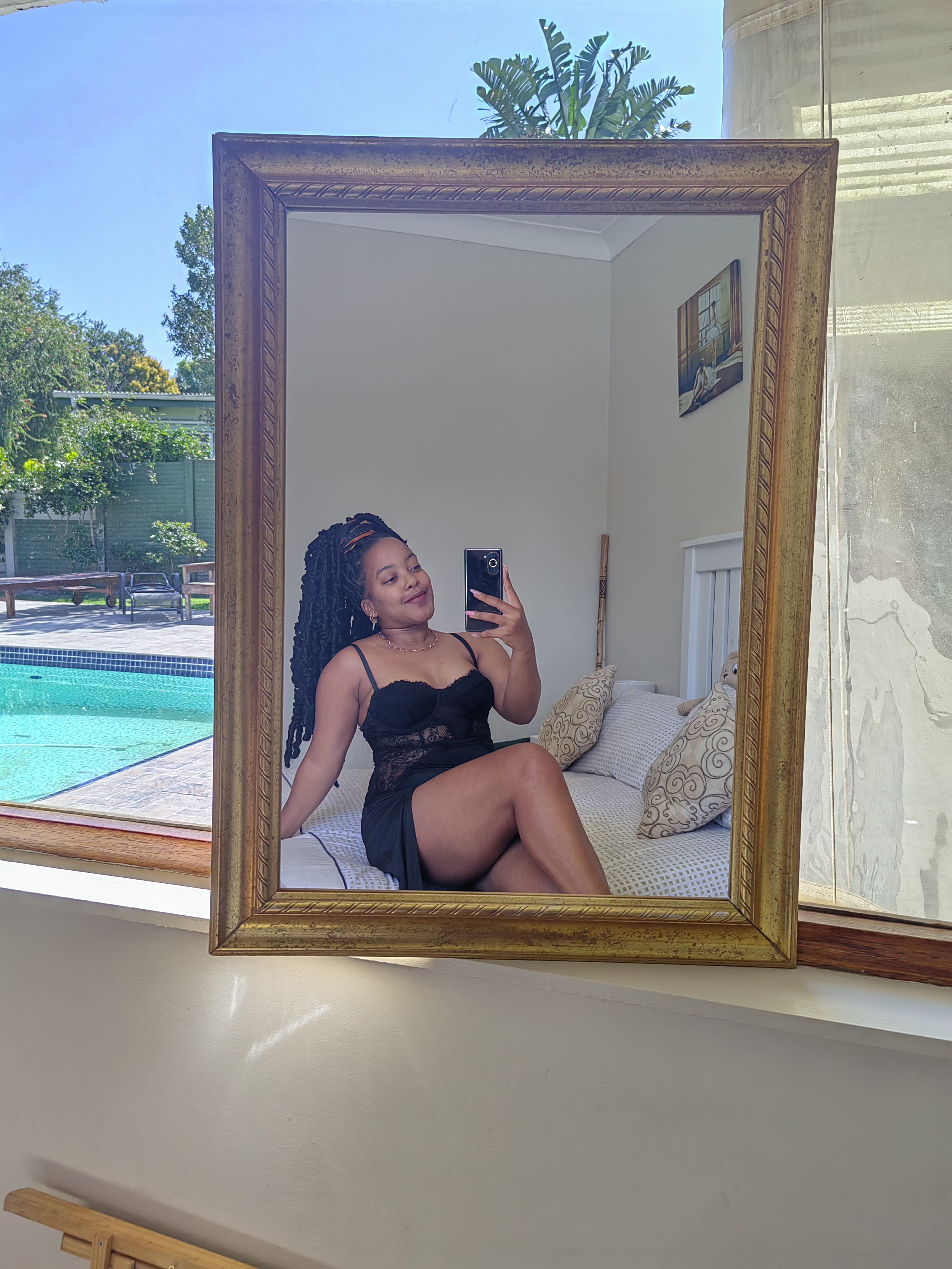 A boudoir mirror with pool light through the window