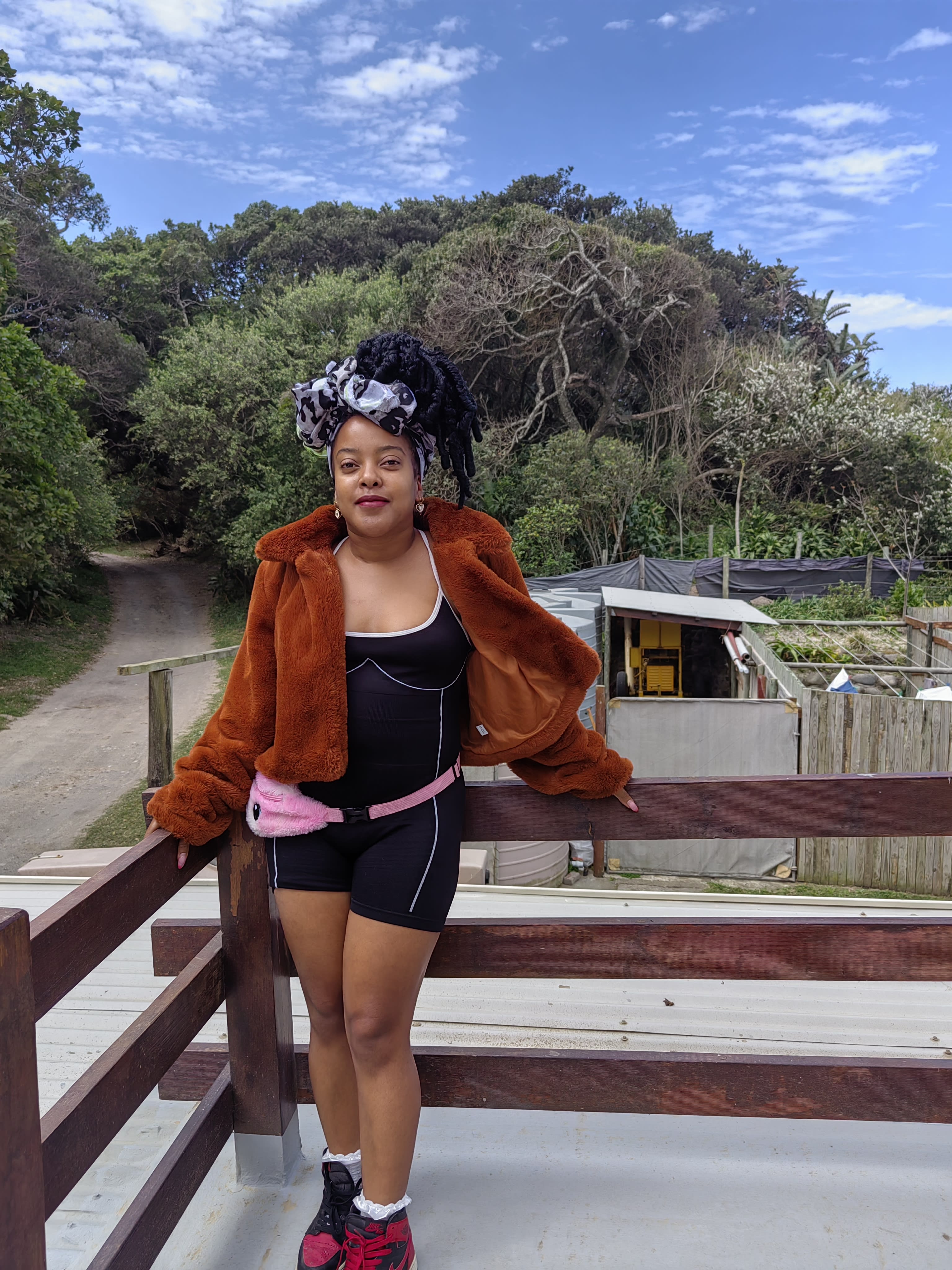Burnt-orange fur and a printed turban on the coast