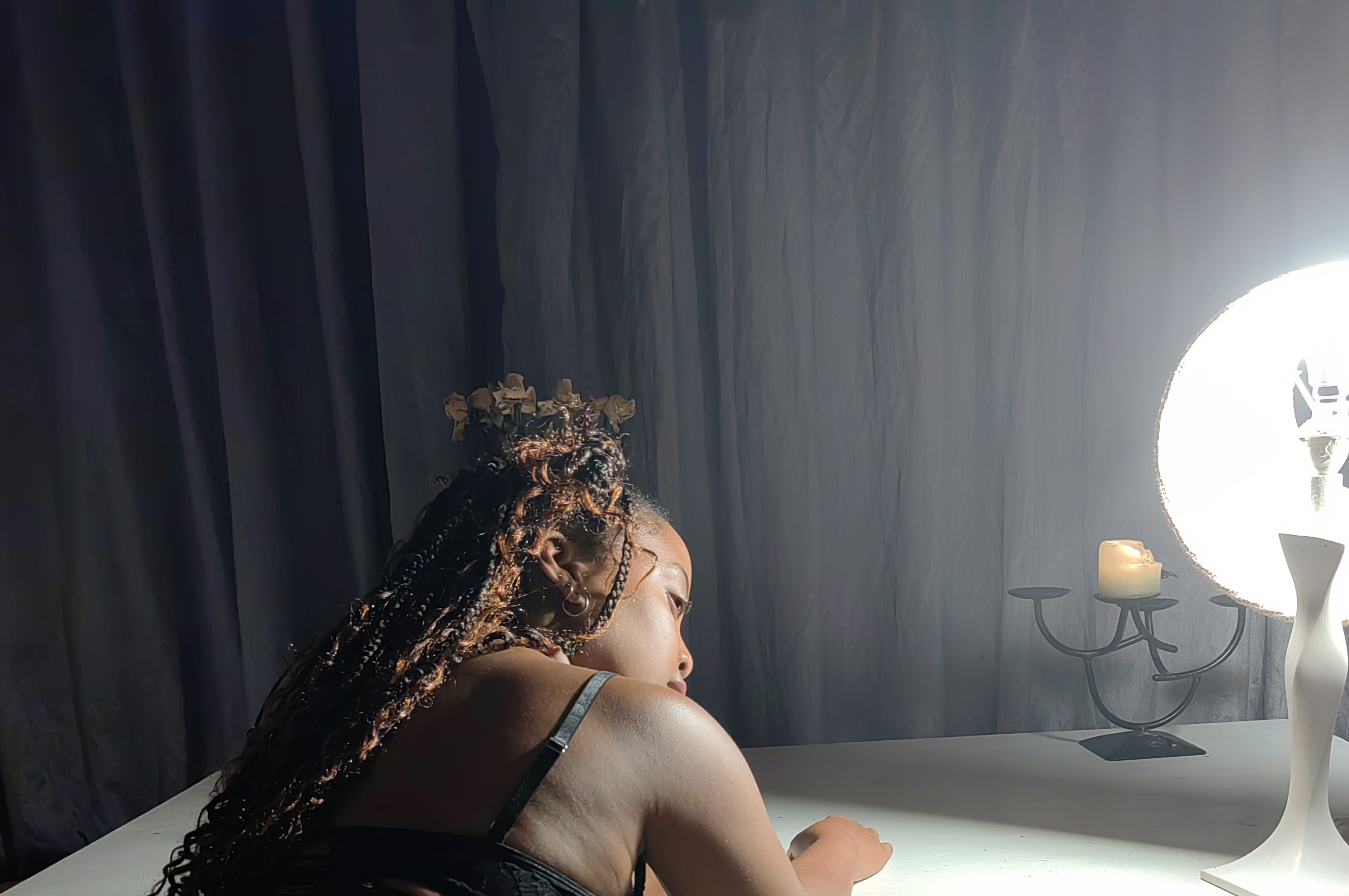 Black lace by candlelight and a glowing orb