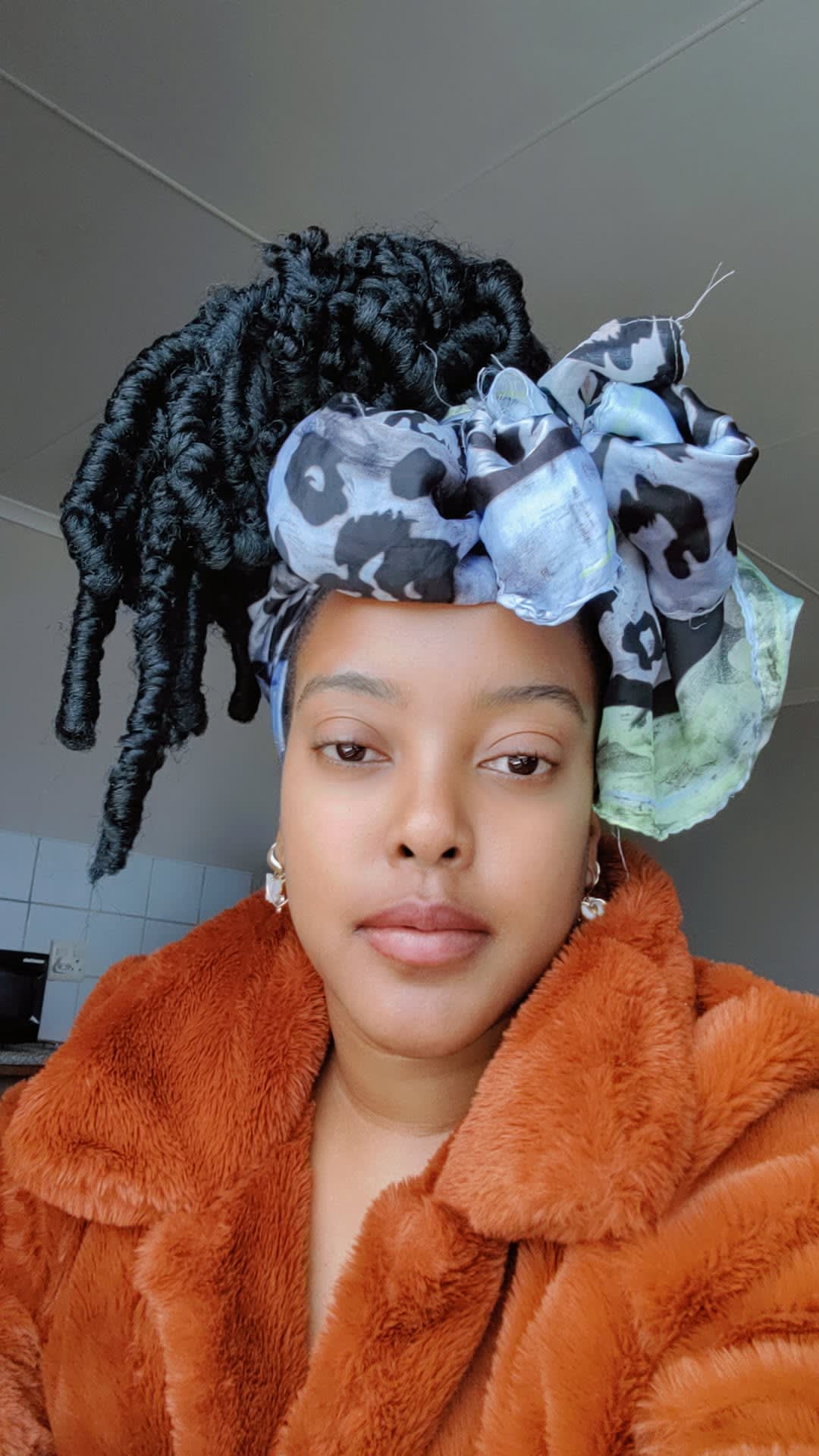 Burnt-orange fur and a leopard headwrap