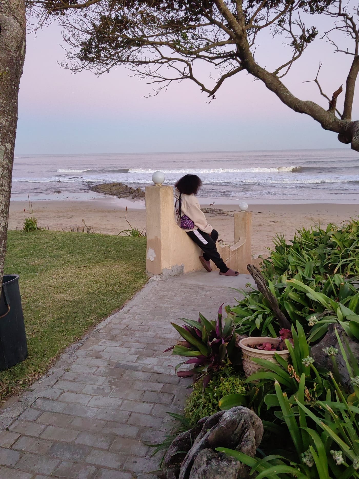 On a sea wall at pastel dusk