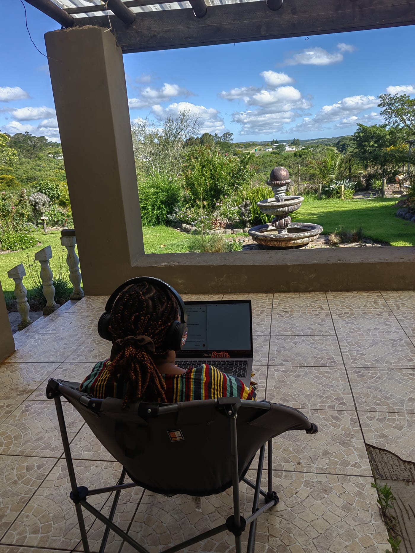 Working on a stoep overlooking a garden and fountain