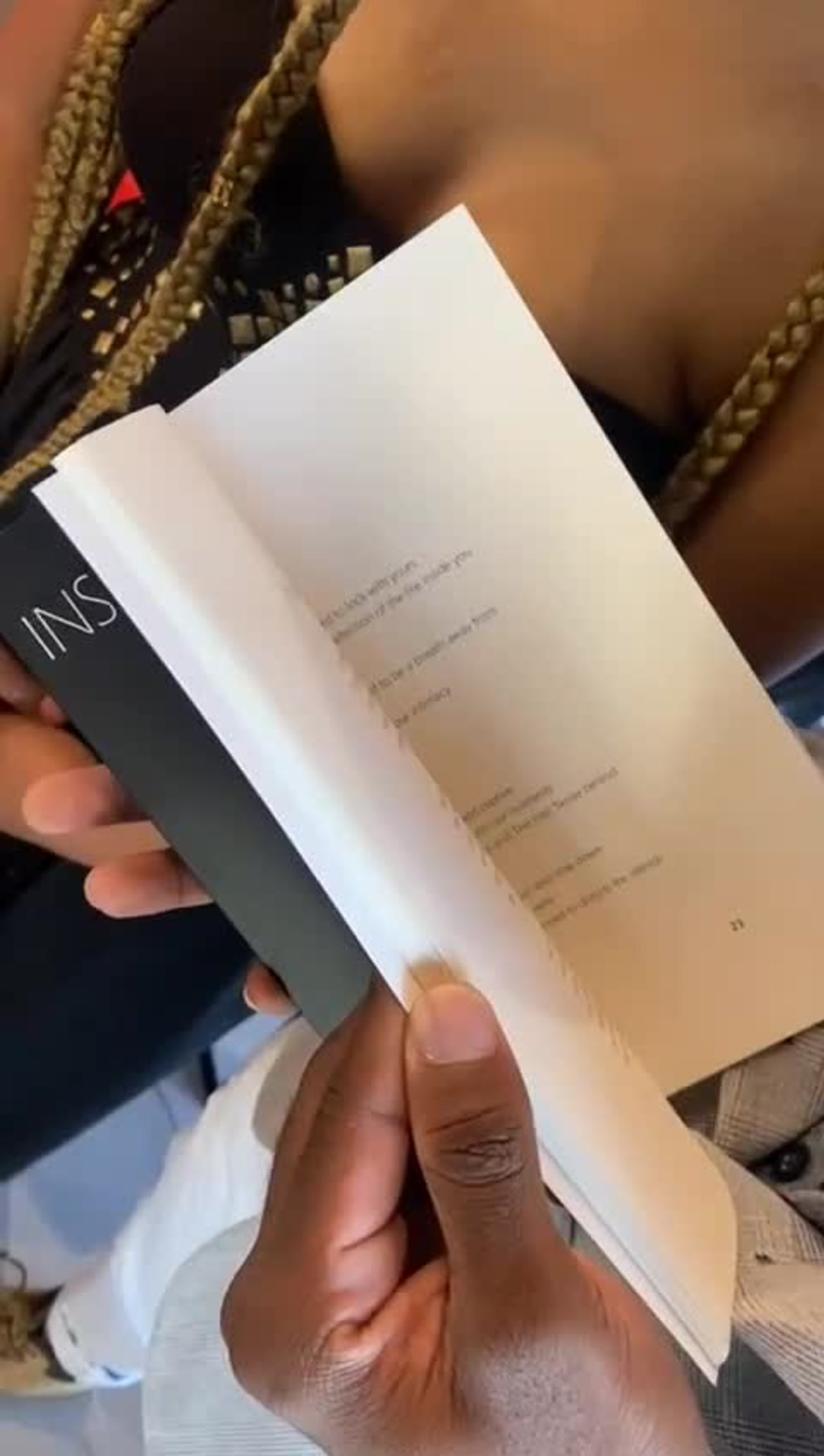 A reader opening Inside Her Roses to a poem