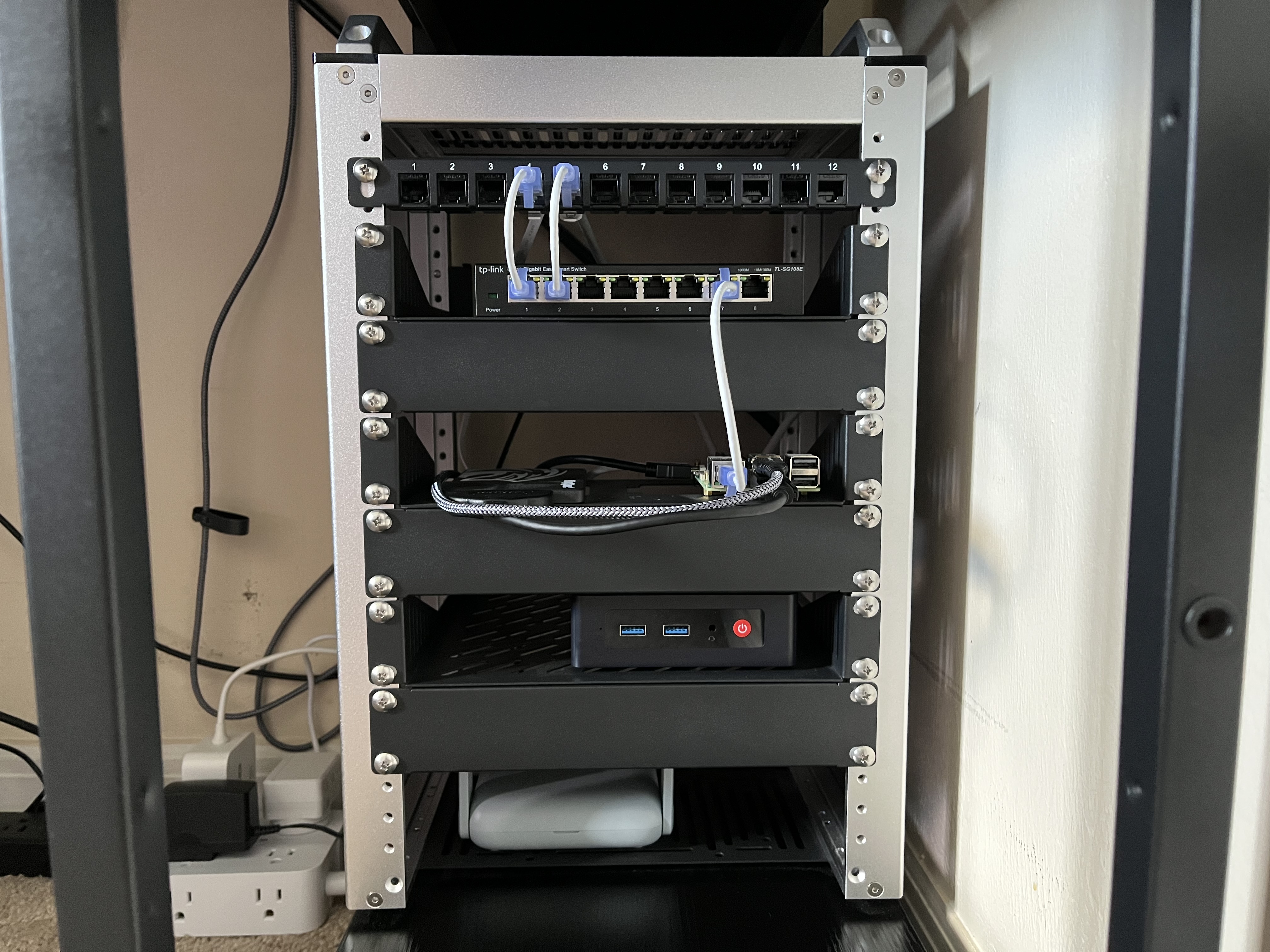 DeskPi RackMate T1 on bottom desk shelf