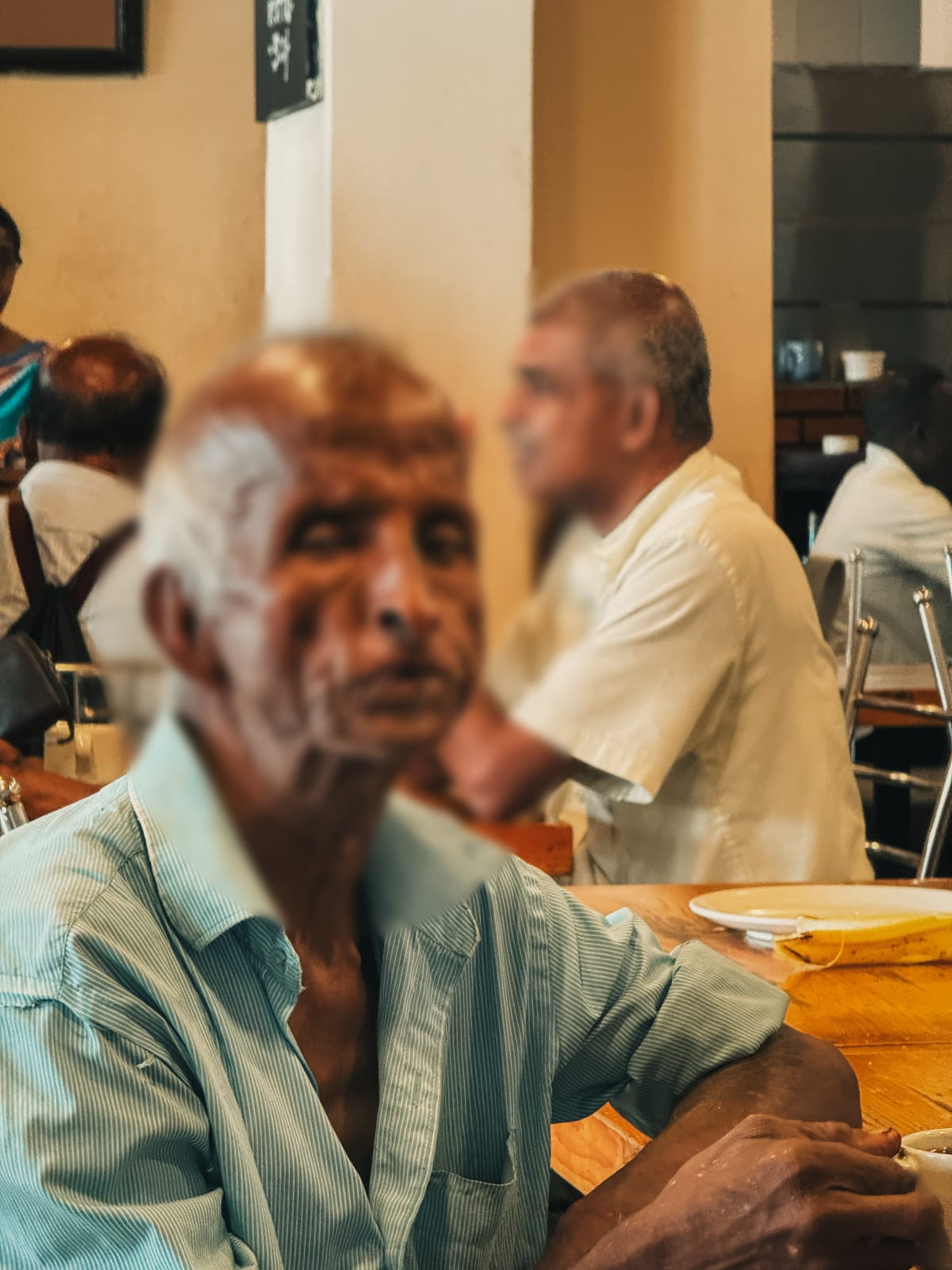 A candid cafe scene I shot in Kandy, Sri Lanka, with the faces of the people blurred for privacy before sharing. Photo by Luca Sammarco.