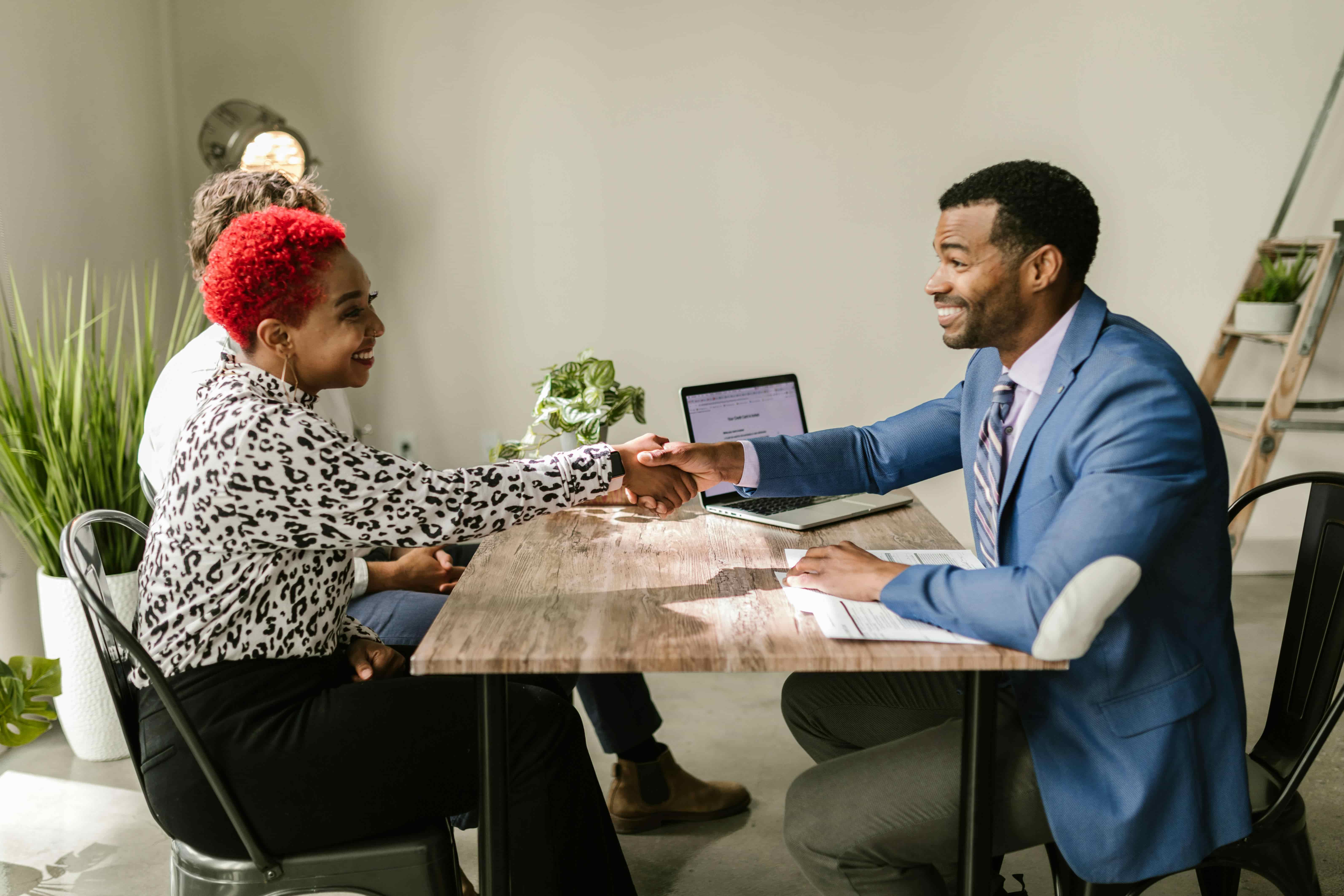 Professional job interview with diverse candidates shaking hands