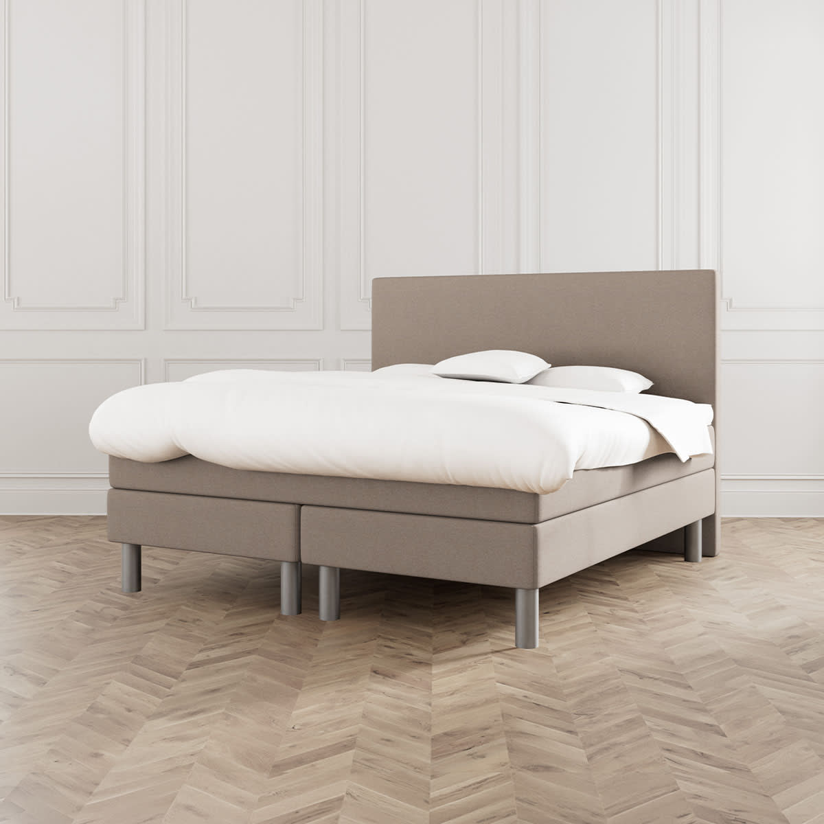 Beige seng Dozy fra MasterBed Standard med hvidt sengetøj og runde ben, set forfra.