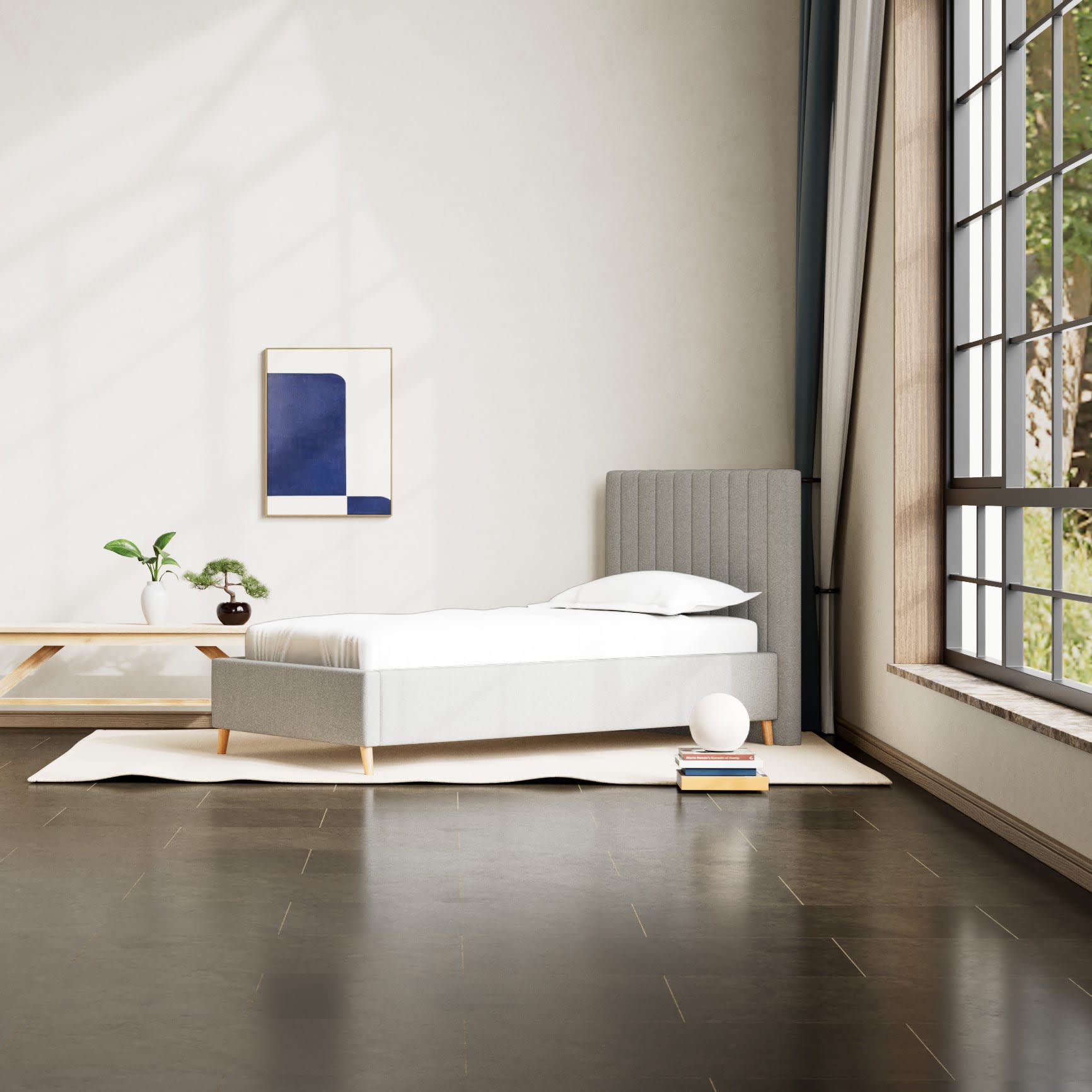 Et lyst, moderne soveværelse med en grå enkeltseng, et stort vindue og minimalistisk kunst på væggen.
