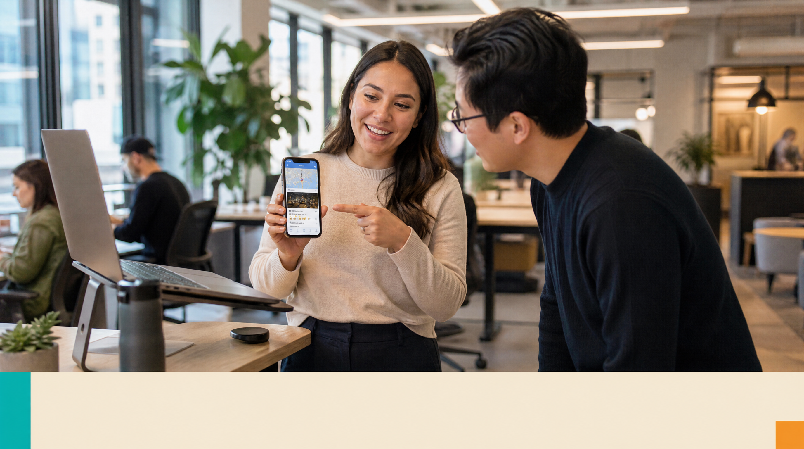 Website Rental — Supporting visual 2: A woman at a standing desk in a modern Toronto co-working space points to her phone screen showing a Google Maps list