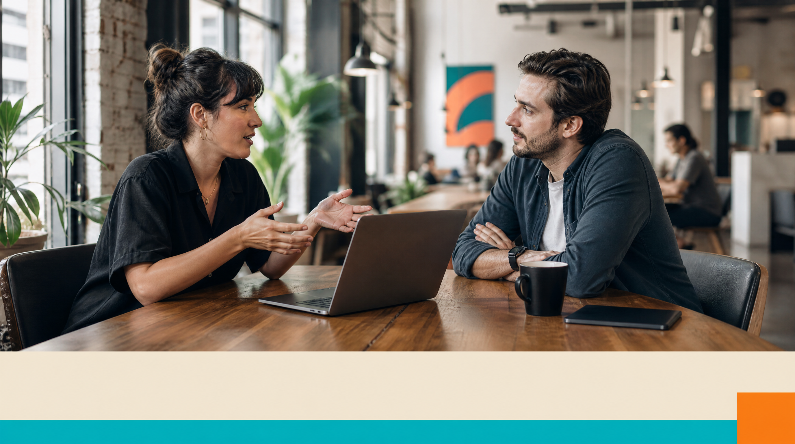 How Do AI Agents Learn? A Plain-English Guide for Small Business Owners — Closing visual: Two colleagues in their 30s sit across from each other at a woode