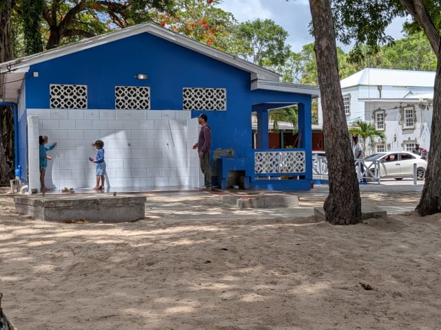 Open-air freshwater shower area beside the public facilities at Folkestone Beach in St. James, Barbados.