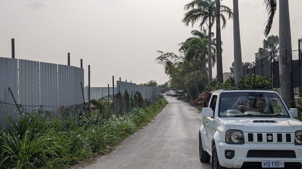 White Suzuki Jimny on the narrow access road leading to Heywoods Beach parking beside Port St. Charles.