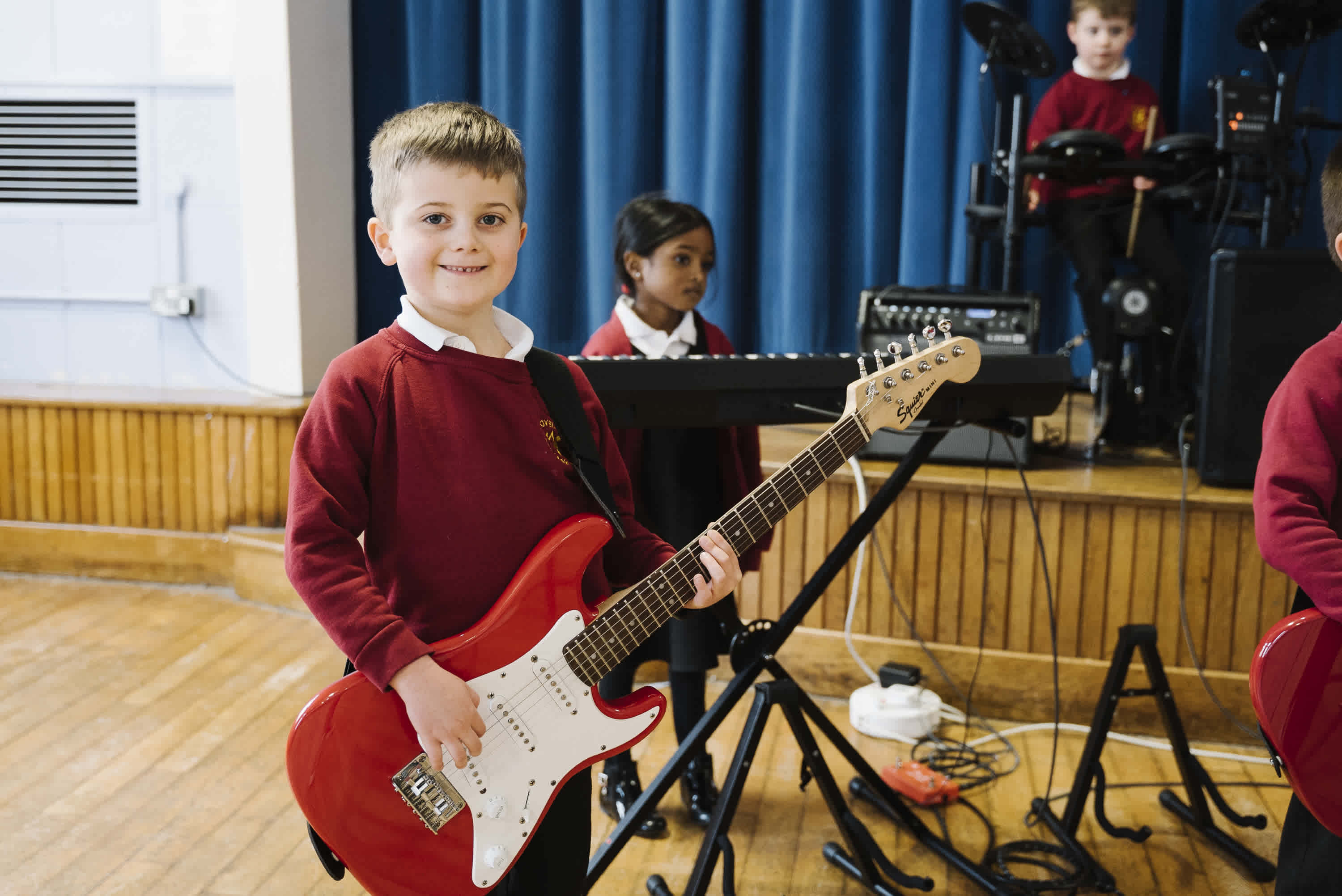 irock student on guitar smiling