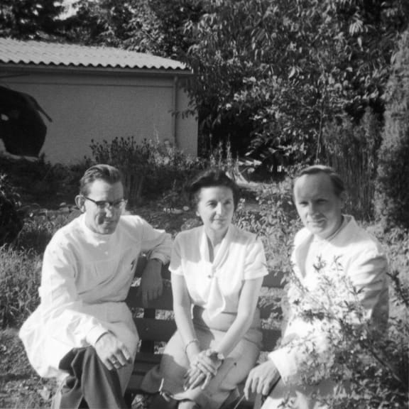 Dr. Reinhard Schoppman, Elizabeth Sigmund, and Rudolf Plantener (left to right) pictured on a bench outdoors.