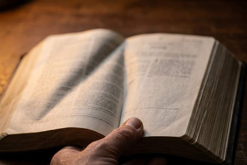 Close-up detail of pages from the Ethiopian Bible showing dense scriptural text and section headers