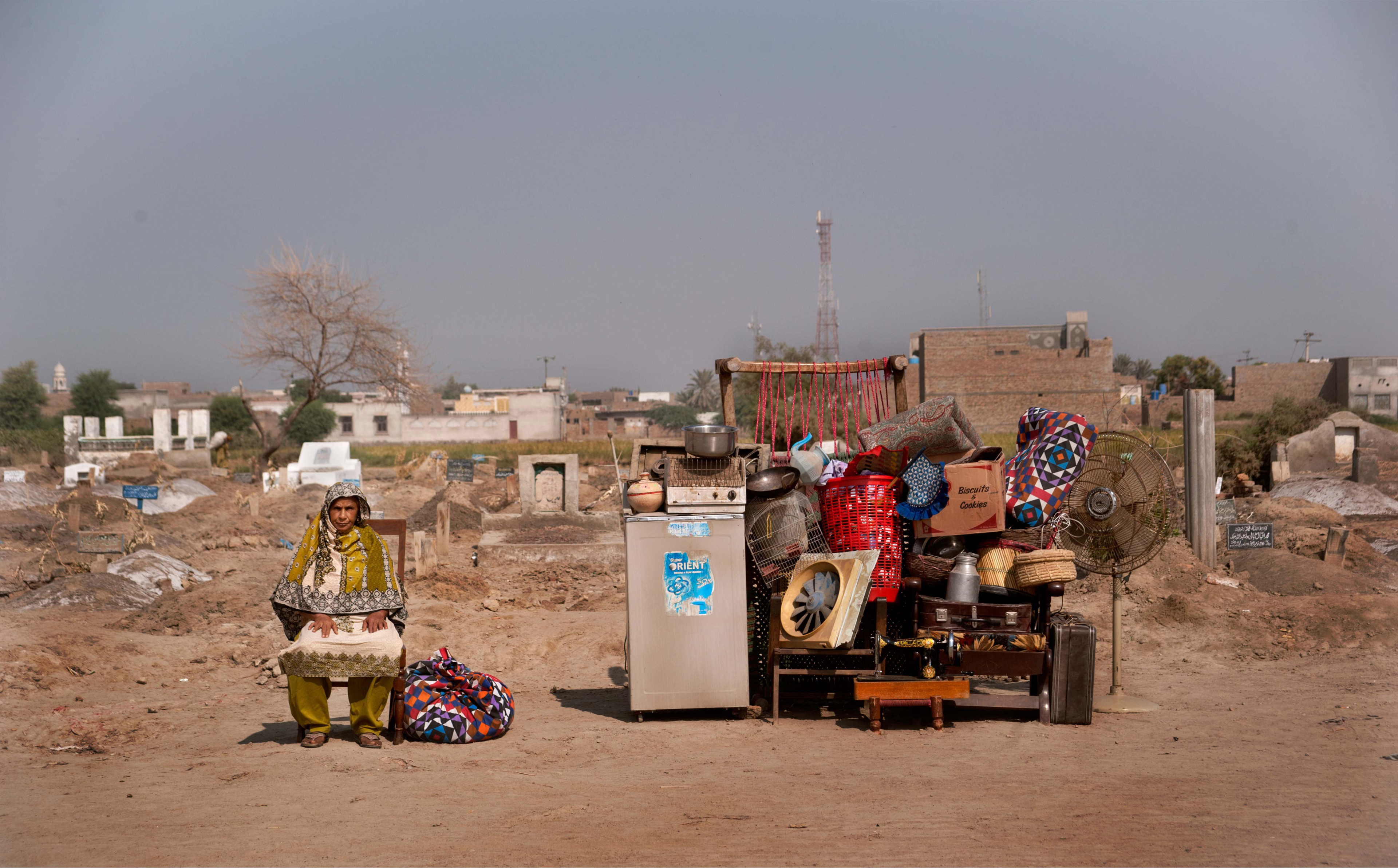 Portrait of an old woman at the edge of a Graveyard