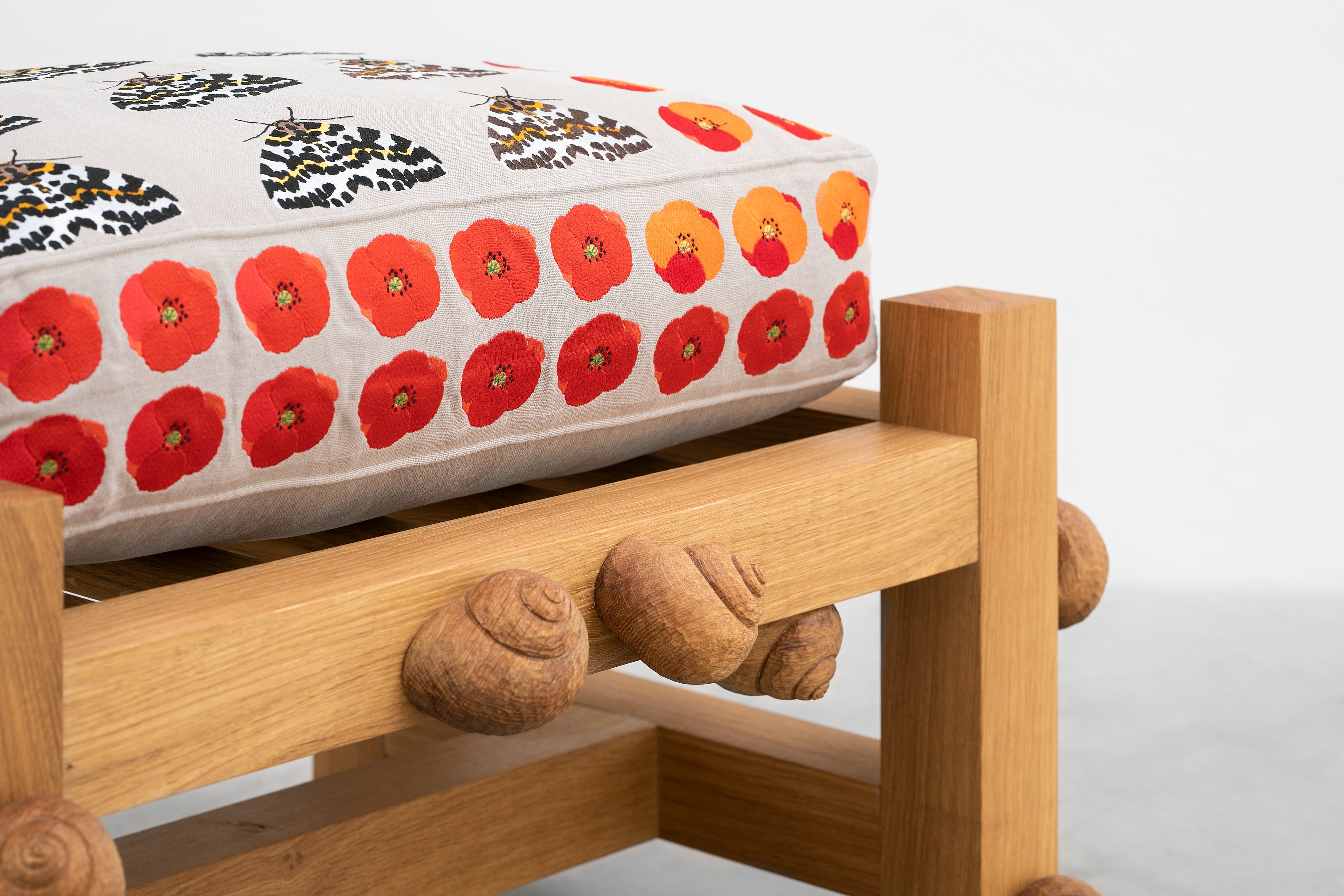 Oak bench with magpie moths, Flanders poppy flowers and snails