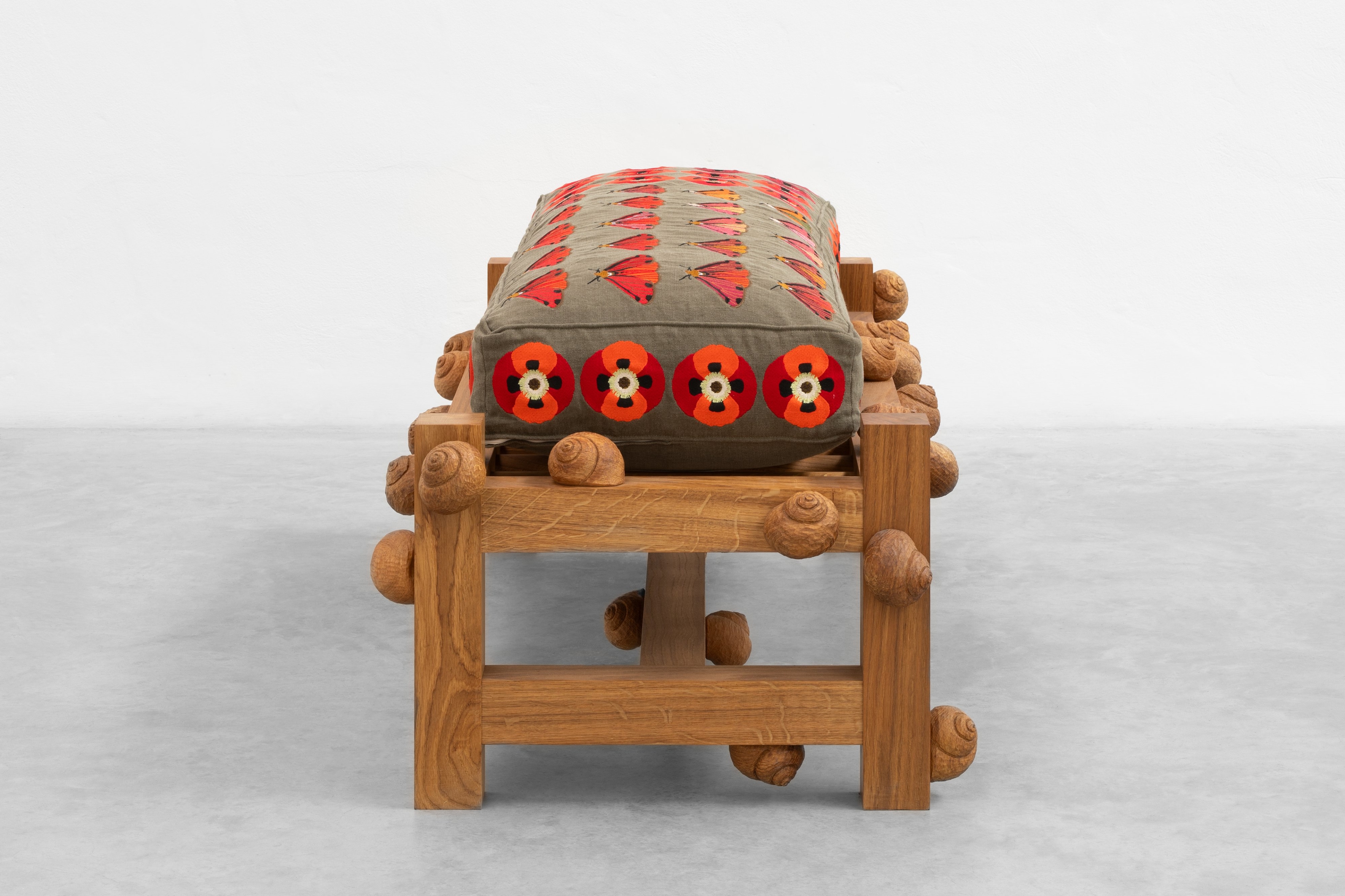 Oak bench with cinnabar moths, opium poppy flowers and snails