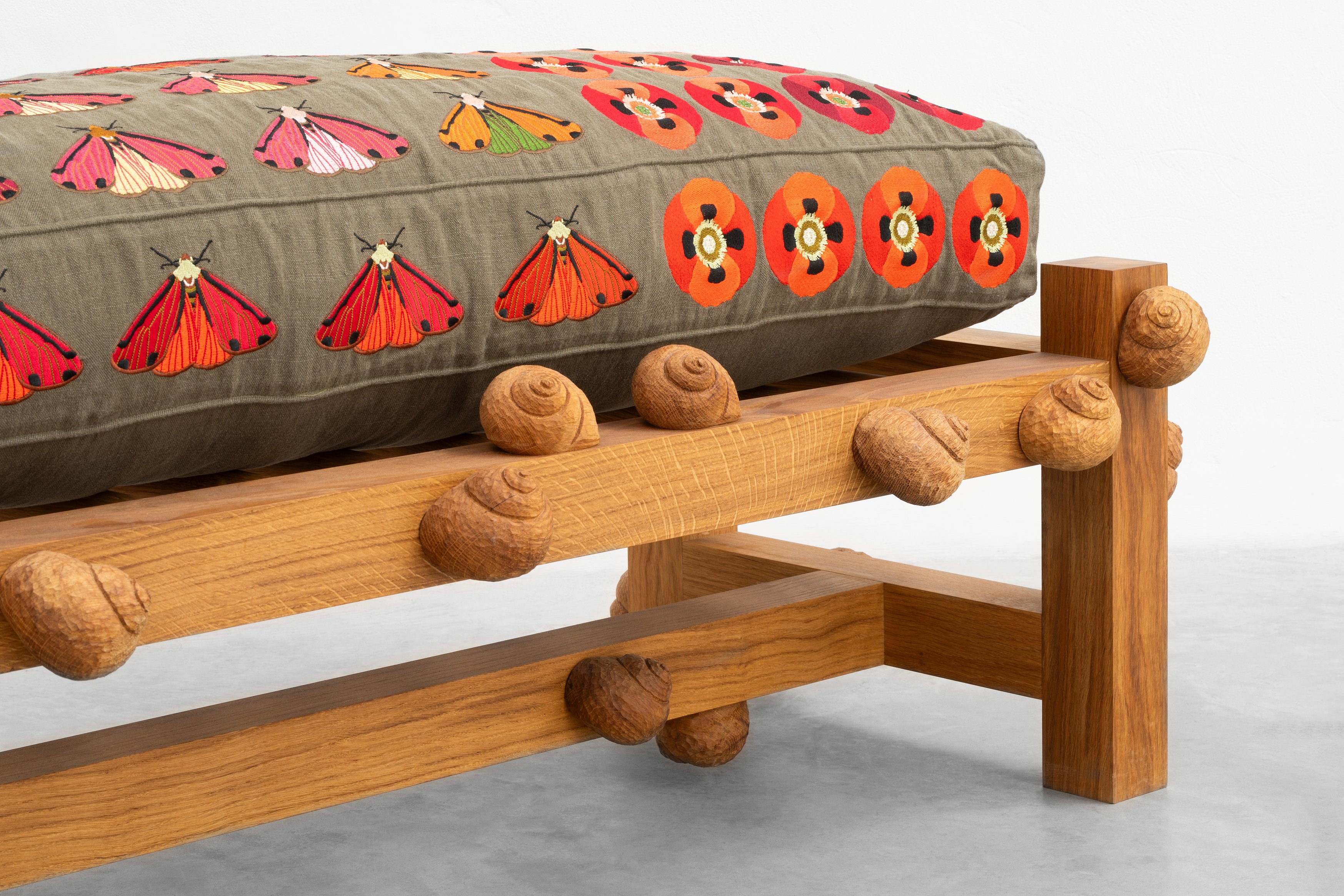 Oak bench with cinnabar moths, opium poppy flowers and snails