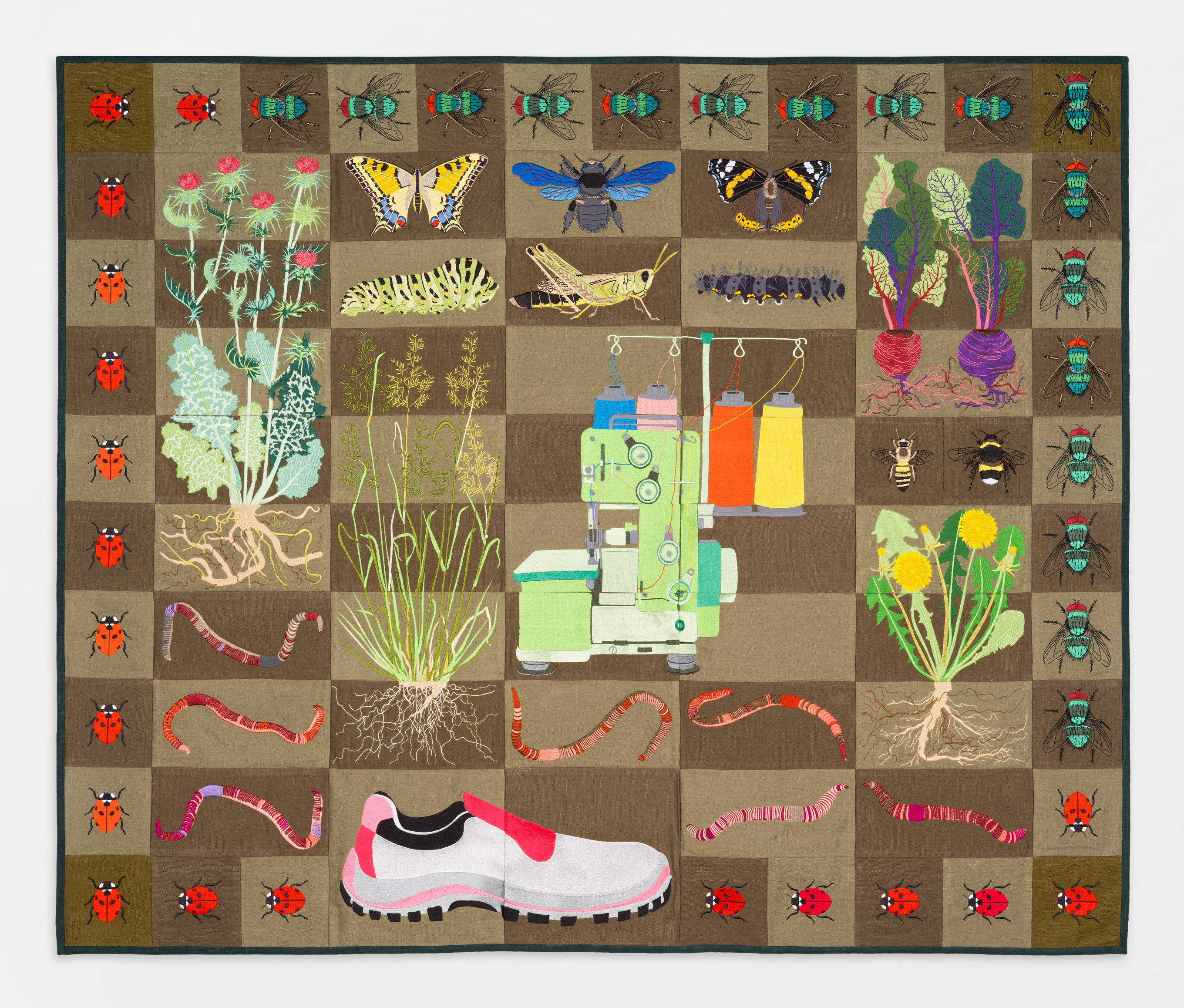 Embroidered quilt with earthworms, meadow fescue grass, dandelion plant, milk thistle plant, honey b...