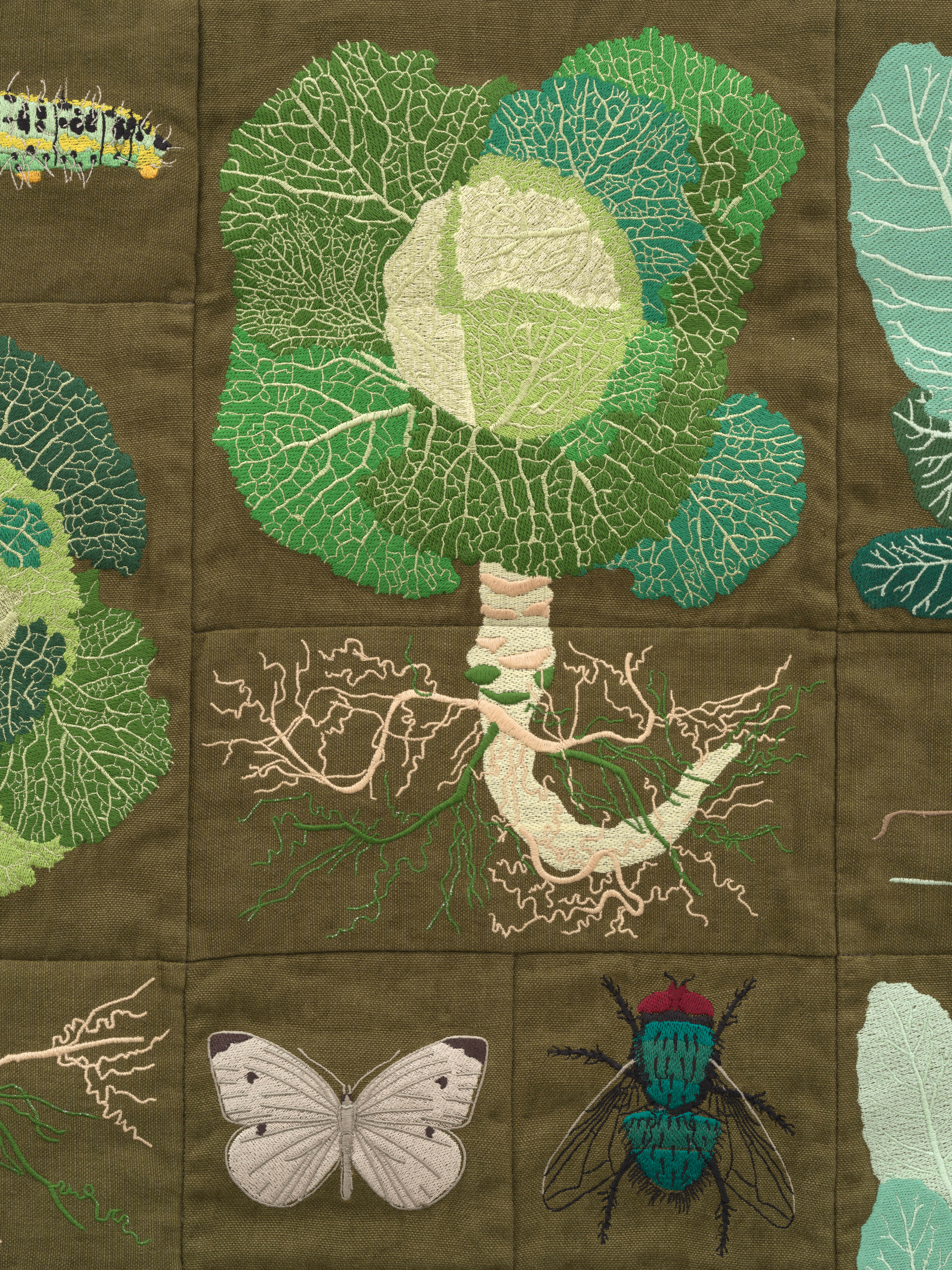 Embroidered quilt with earthworms, Brussels sprout plants, Savoy cabbage plants, cauliflowers plants...