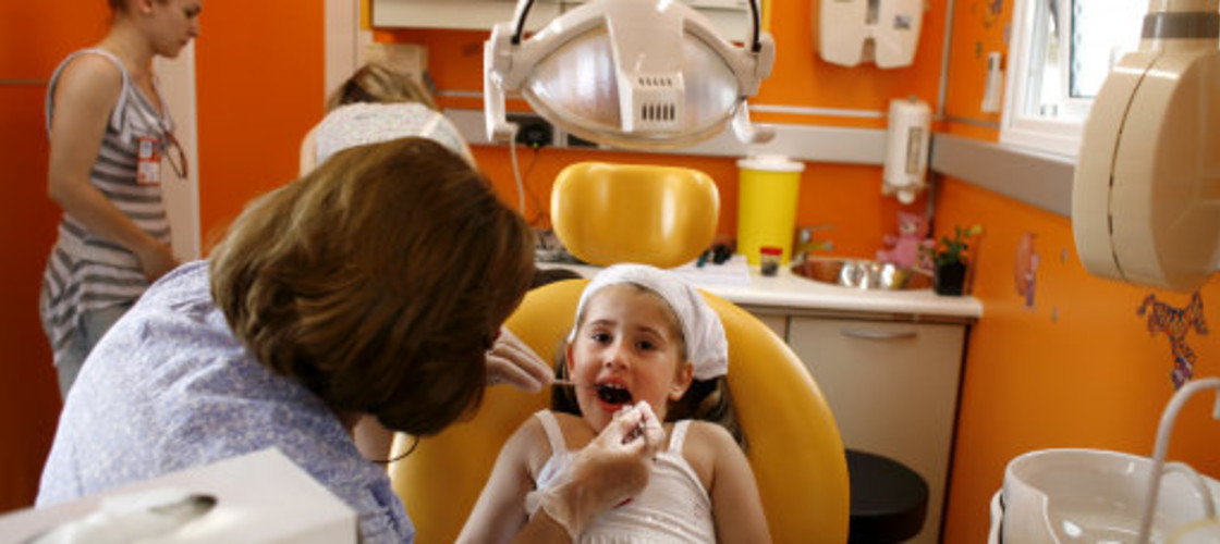 A dentist examines a patient A dentist examines a patient