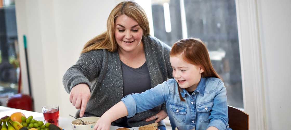Mother preparing food for daughter Mother preparing food for daughter