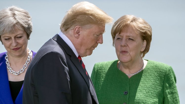 Theresa May warns Russia against 'malign' election meddling amid chaotic G7