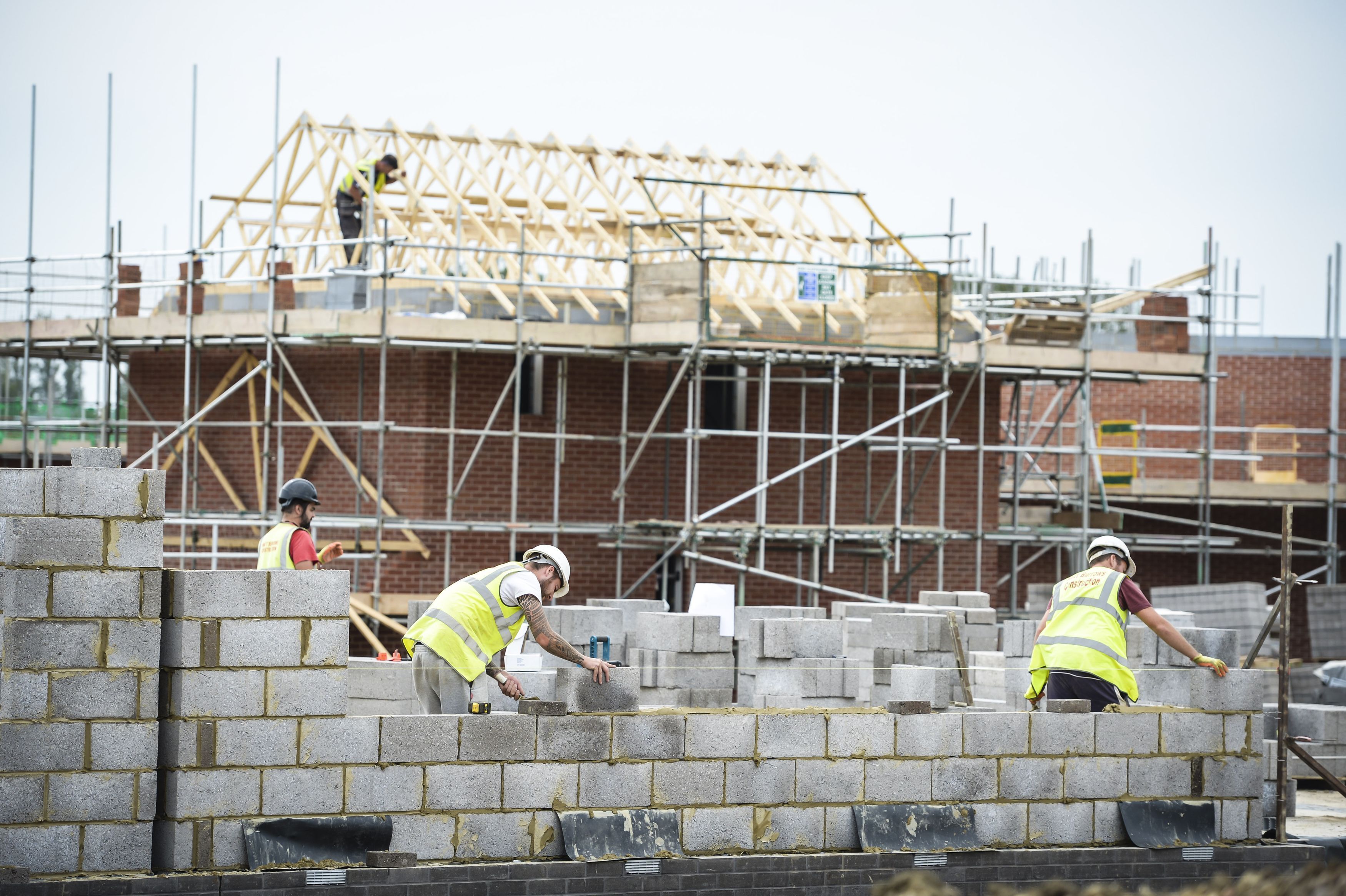 Builders lay blocks on a building site near Bristol, Builders lay blocks on a building site near Bristol,